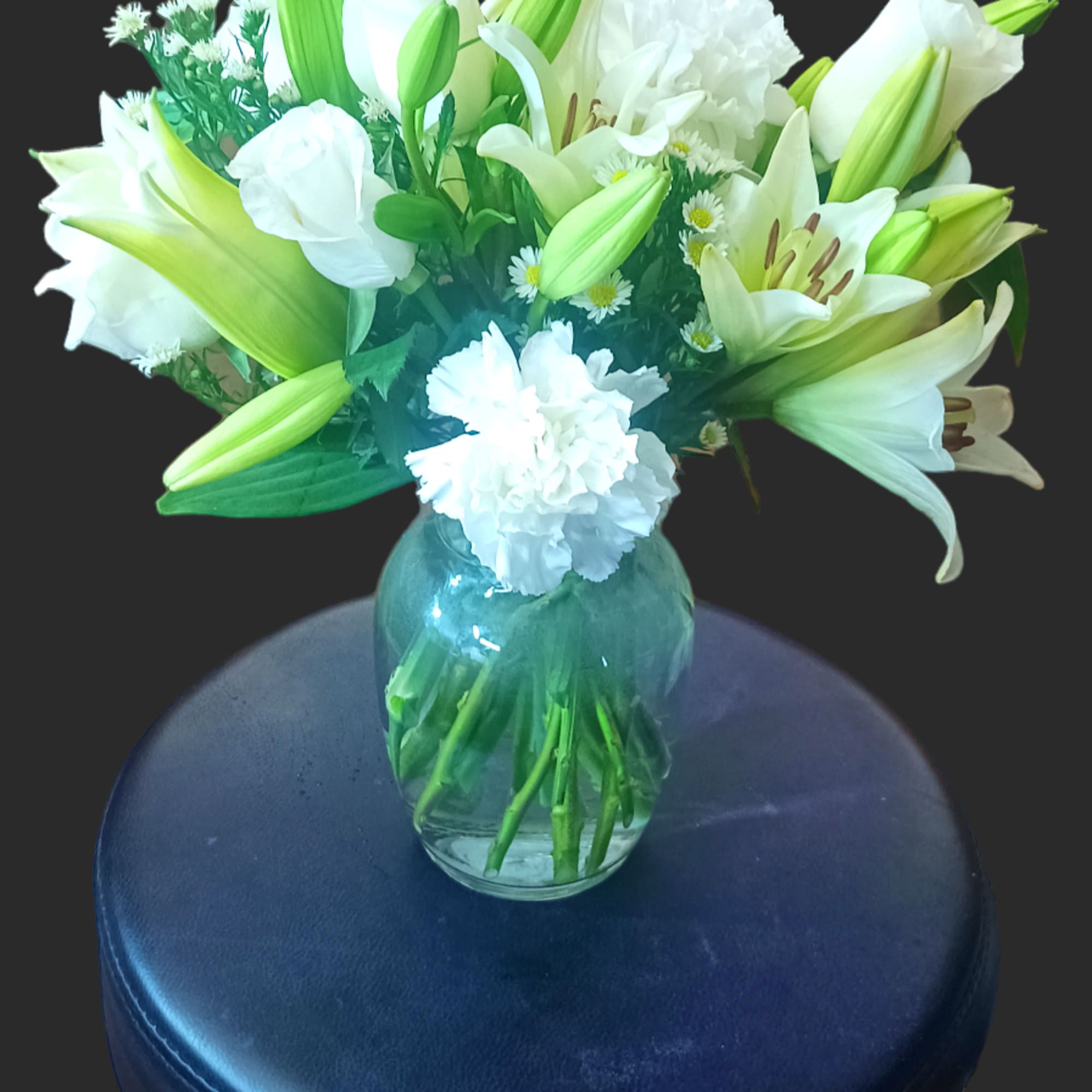 This arrangement includes white roses, white asiatic lilies, white and white carnations., photo 3 of 3