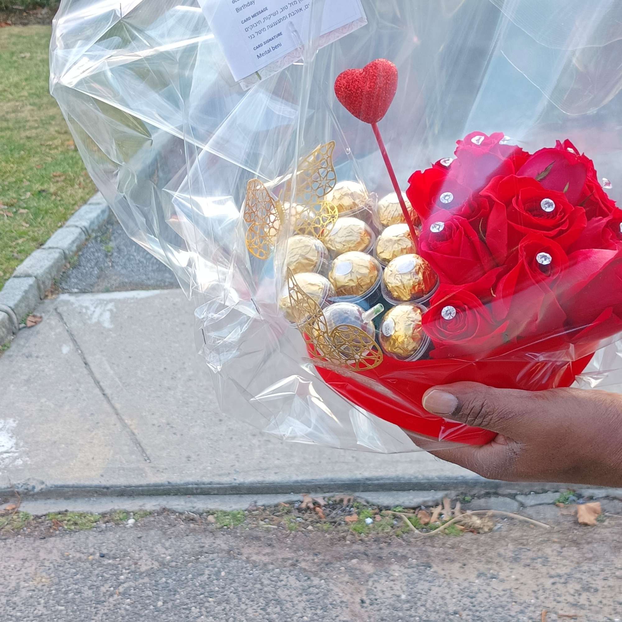 Red rose bouquet with Ferrero Rocher chocolates in clear wrap