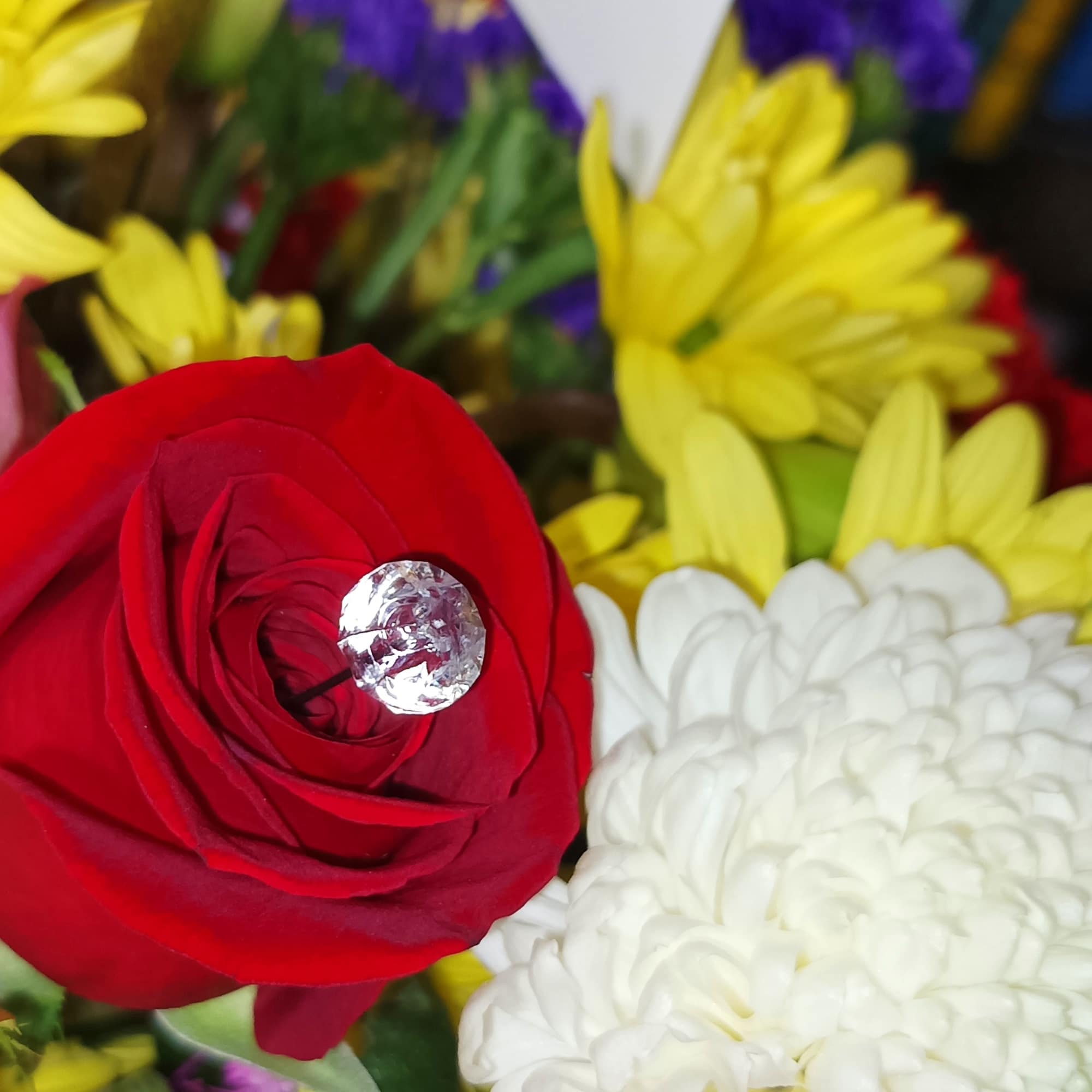 Bouquet with a red rose, white chrysanthemum, and yellow daisies