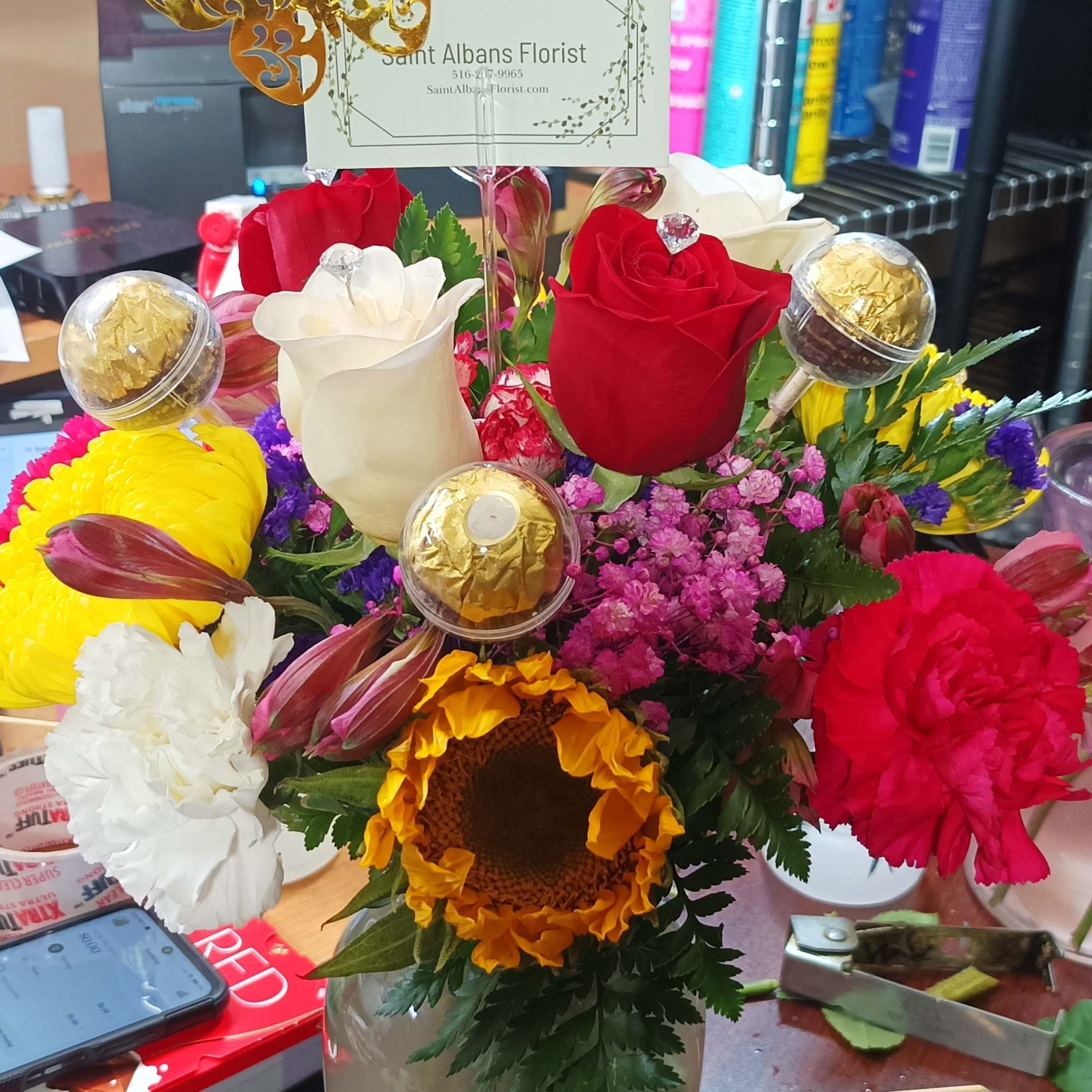 Mixed bouquet in a glass vase with roses, carnations, and a sunflower, photo 2 of 5