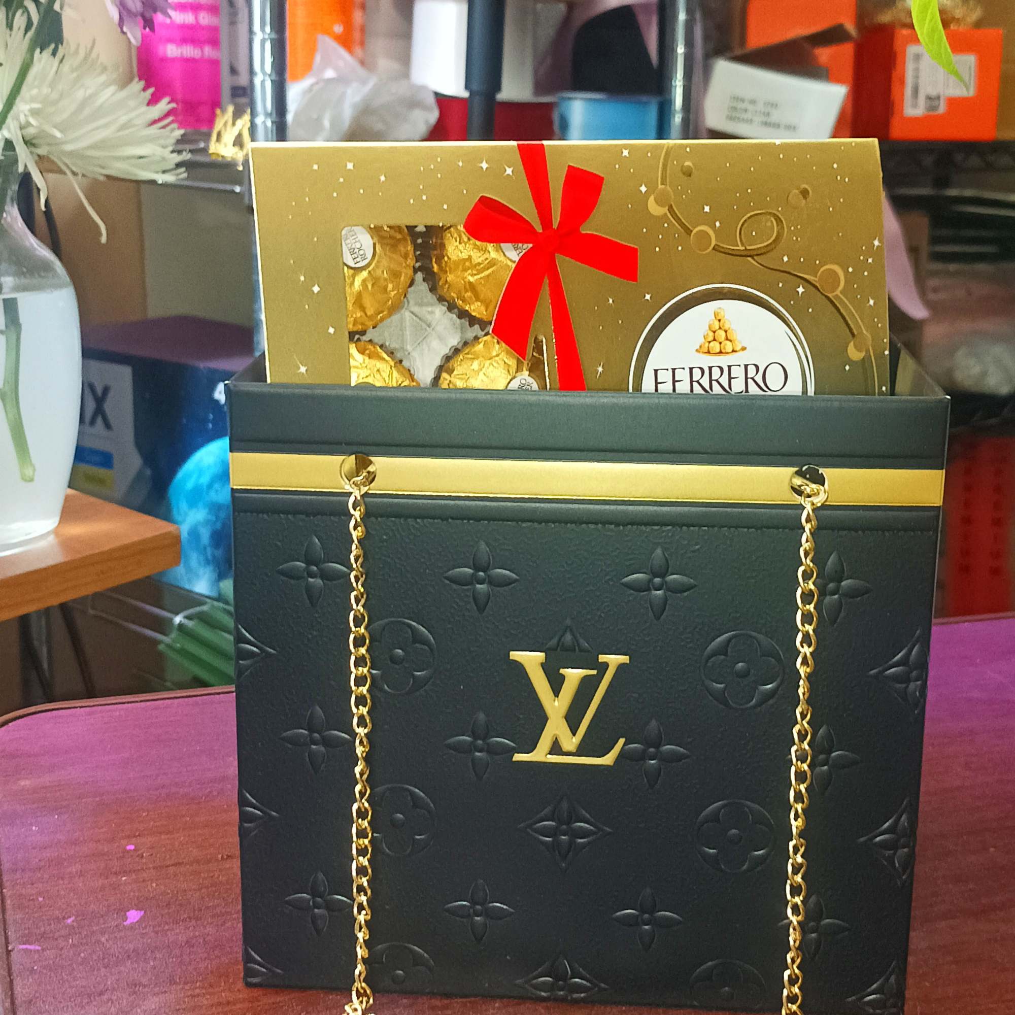 Gift bag with Ferrero Rocher chocolates and a black-and-gold chain handle