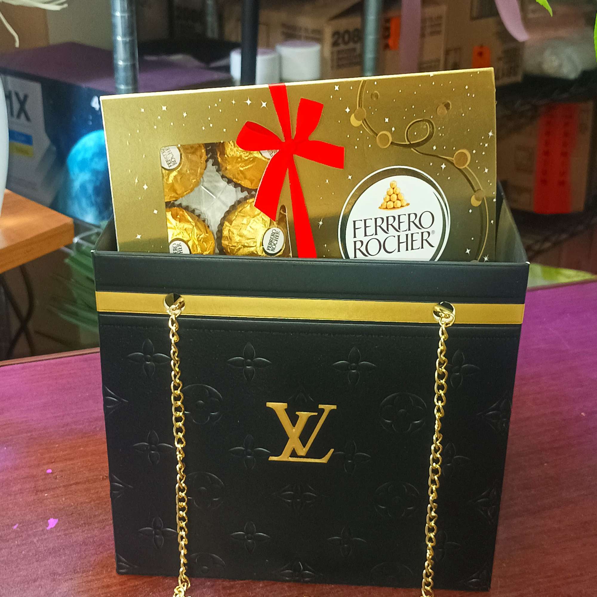 Ferrero Rocher chocolates in a black gift bag with gold chain handles