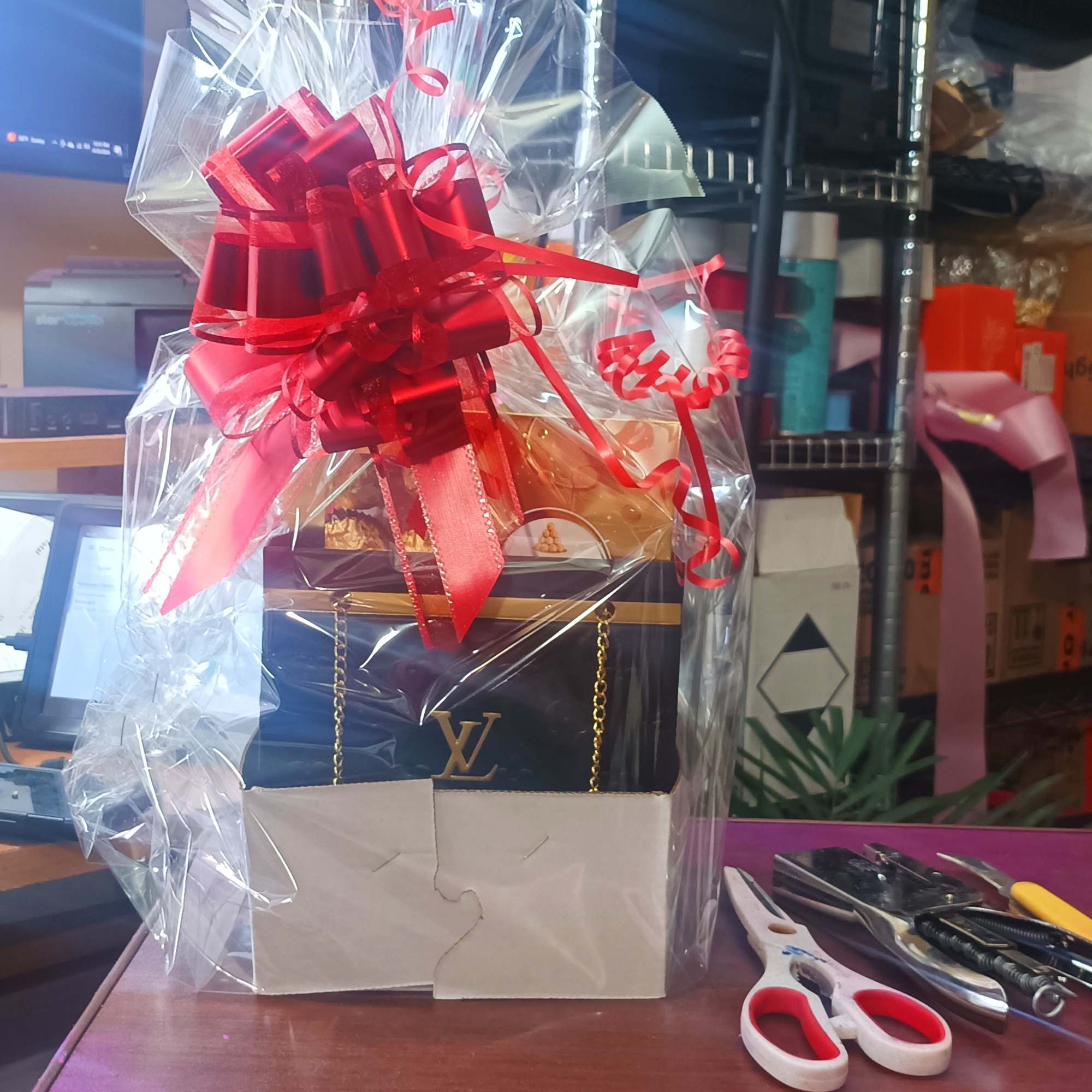 Wrapped gift basket with a red bow and ribbon