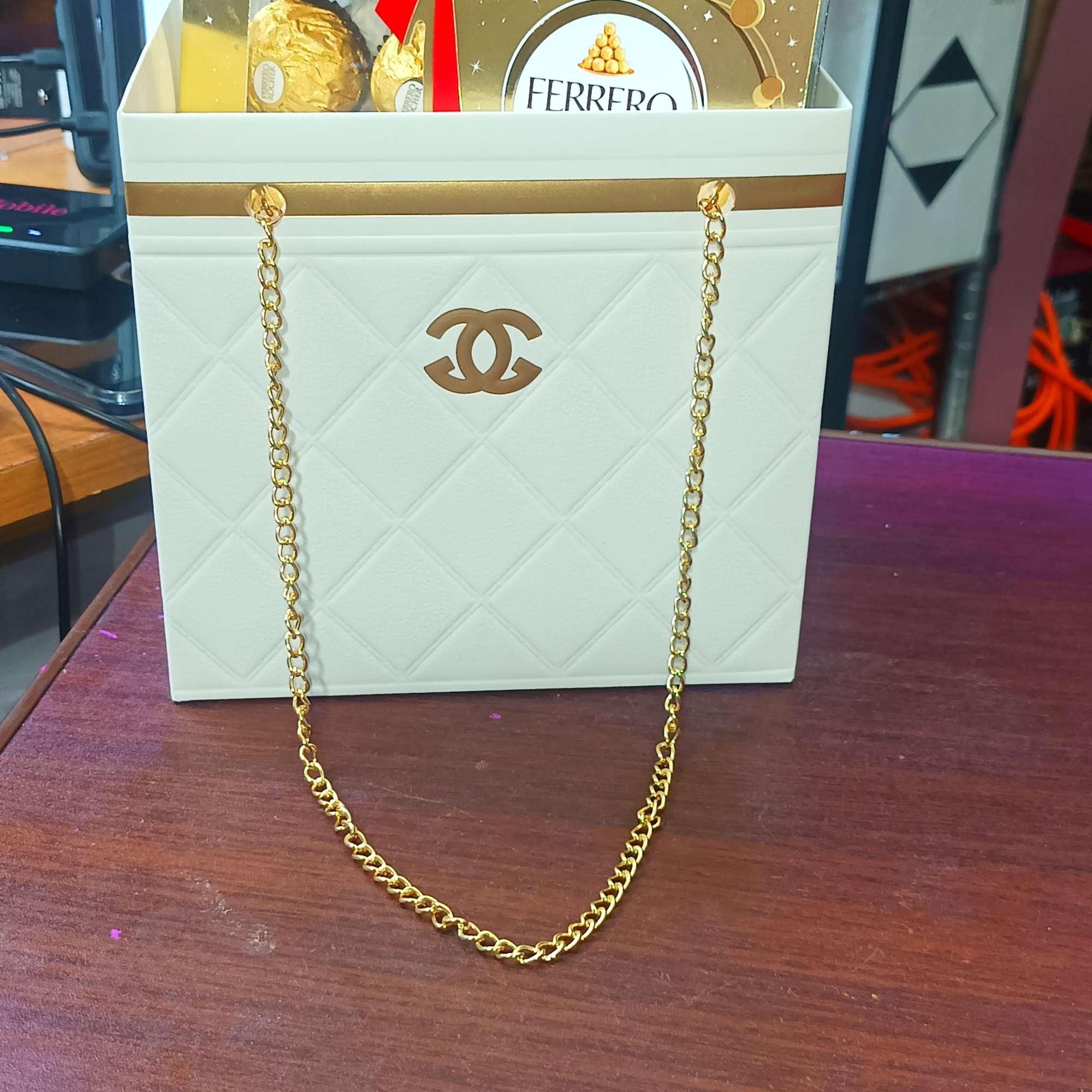 Gift bag with Ferrero Rocher chocolates and a gold chain handle
