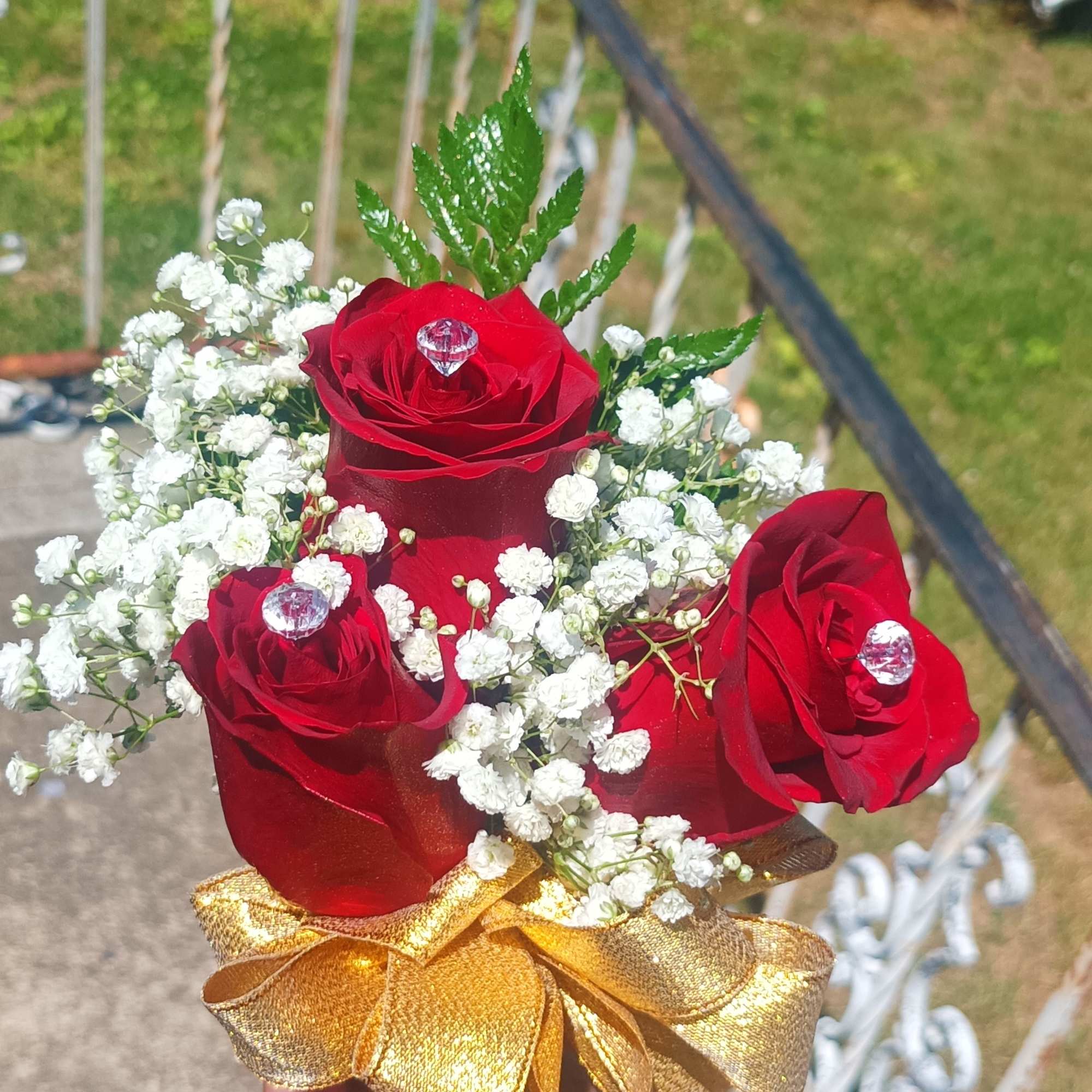 Small bouquet of red roses and white baby's breath with a gold ribbon, photo 3 of 8