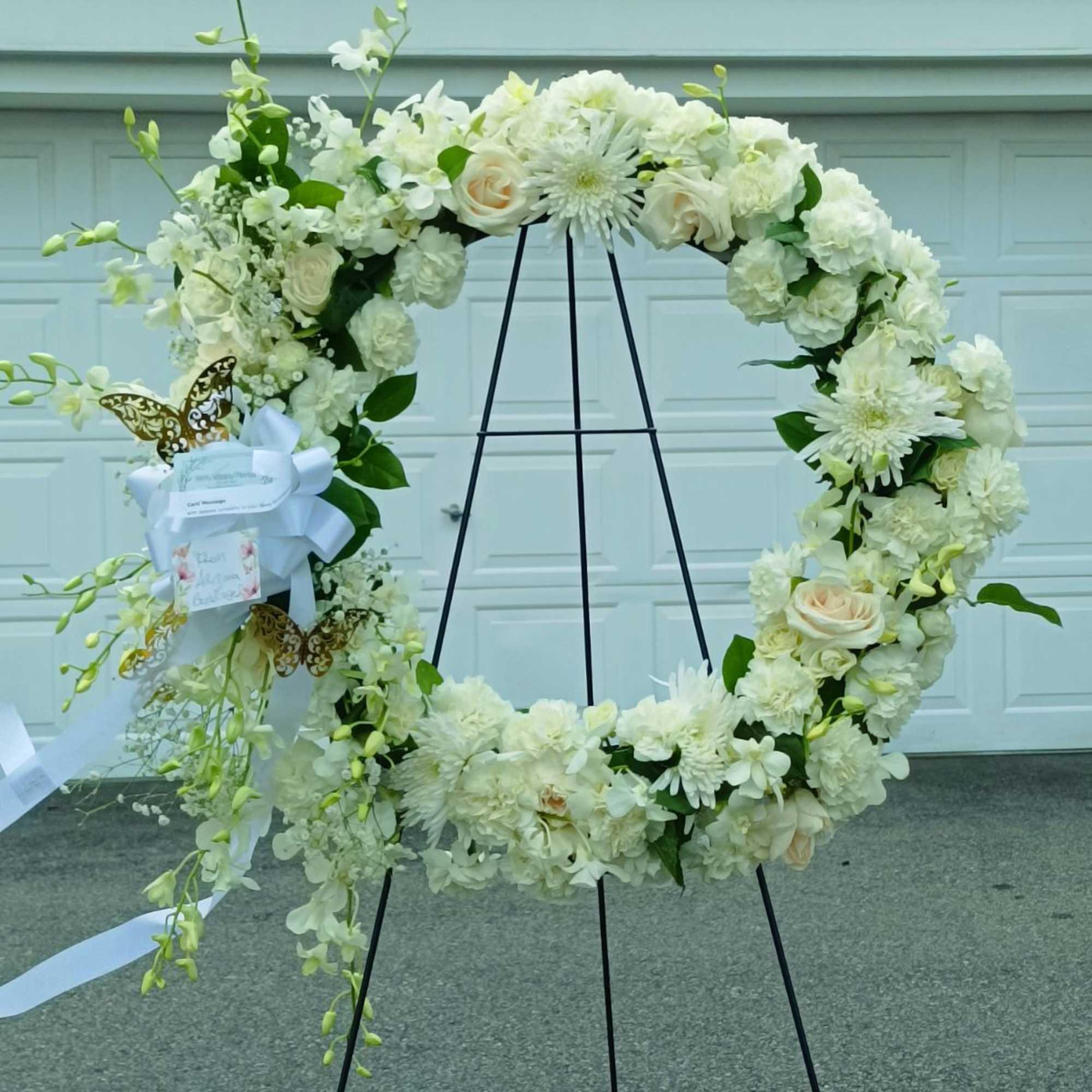 A beautiful white and green tribute wreath that calms, this easel arrangement
