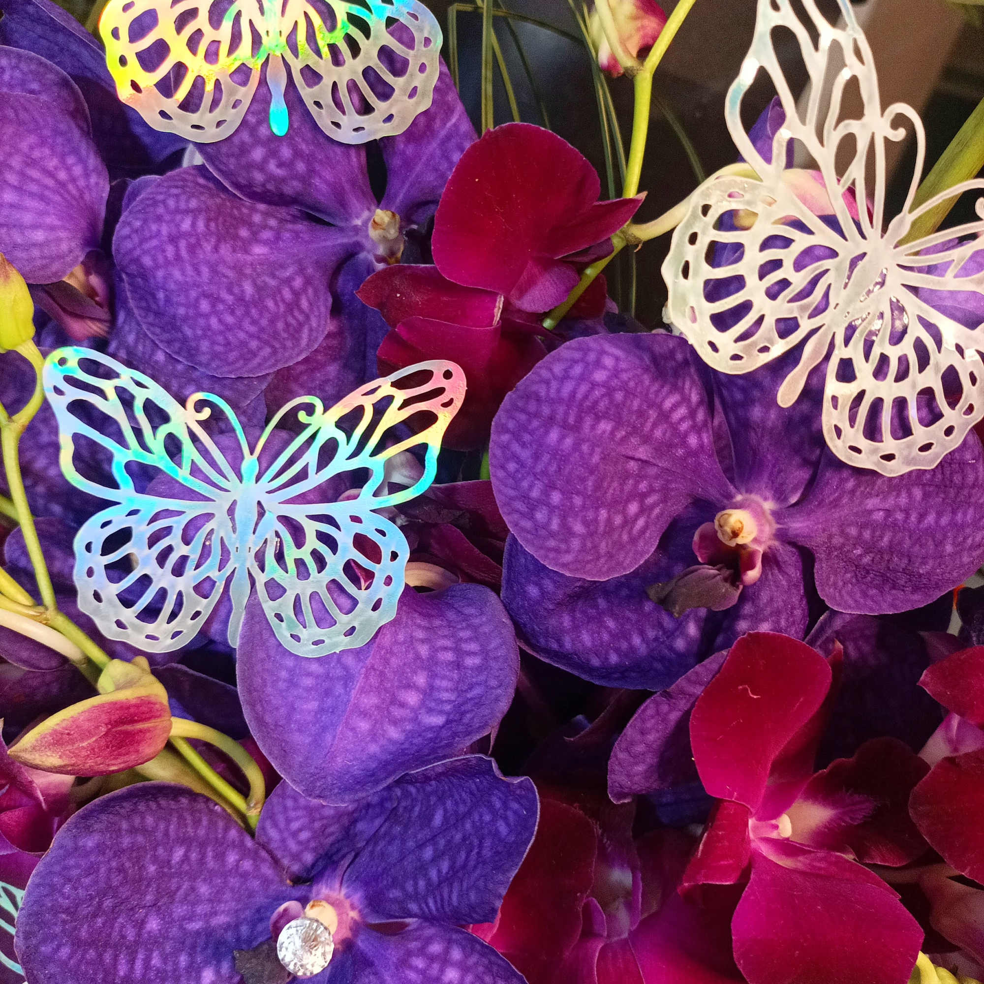 Purple orchids with iridescent butterfly decorations