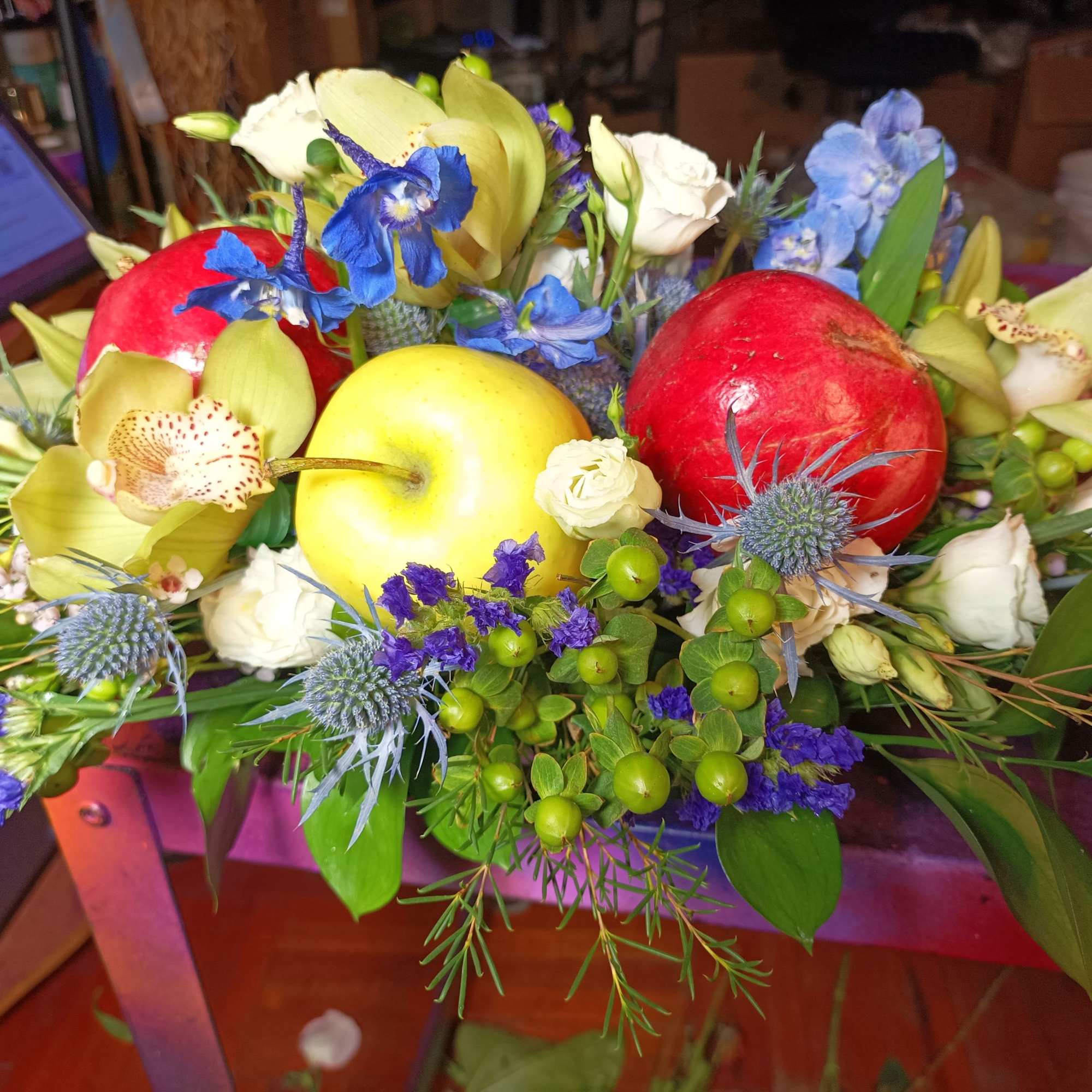 Mixed floral arrangement with apples and blue thistles