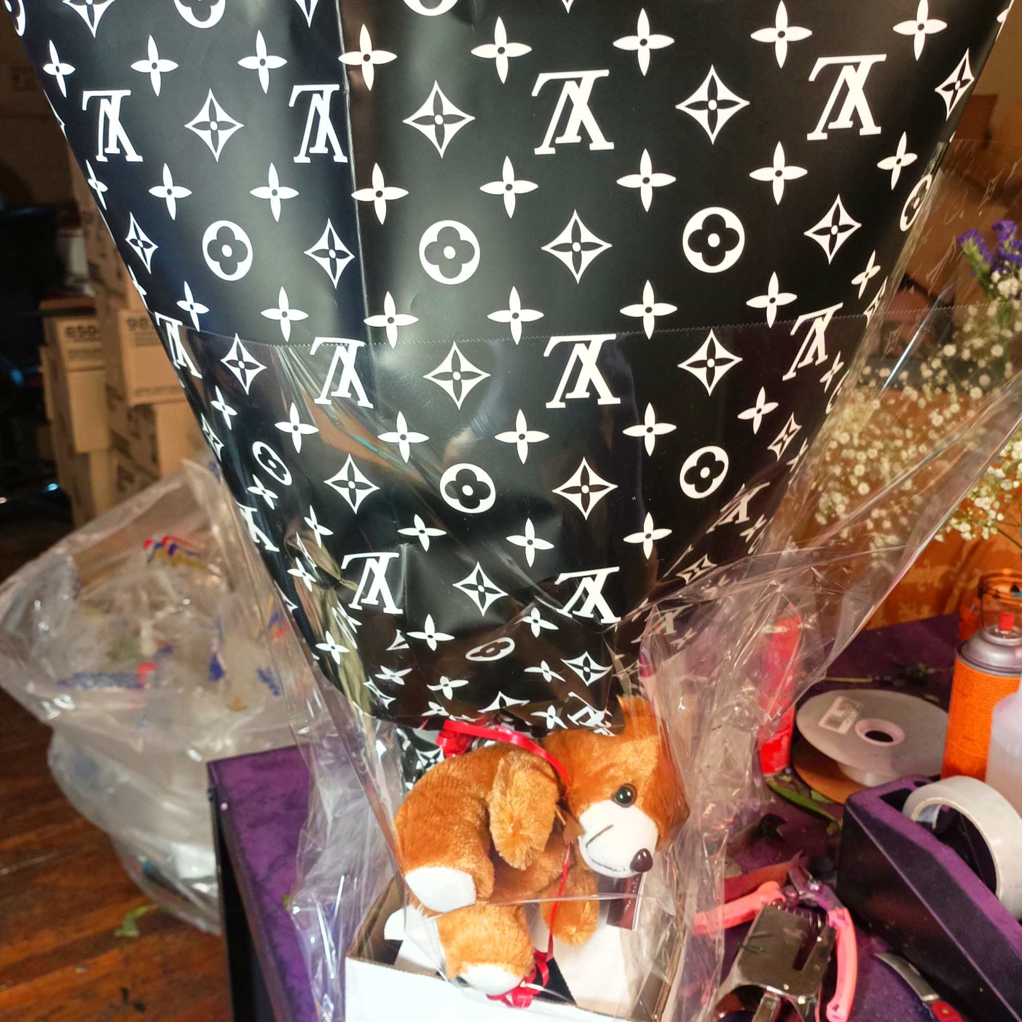 Wrapped gift with a teddy bear in a black patterned cone