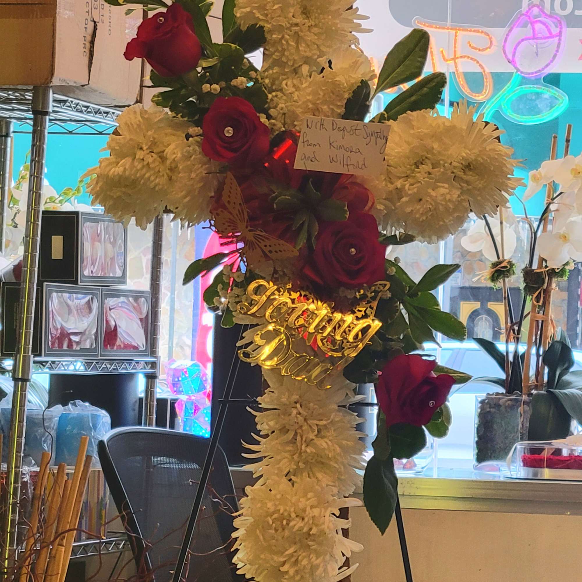 Tall floral standing cross with white chrysanthemums and red roses