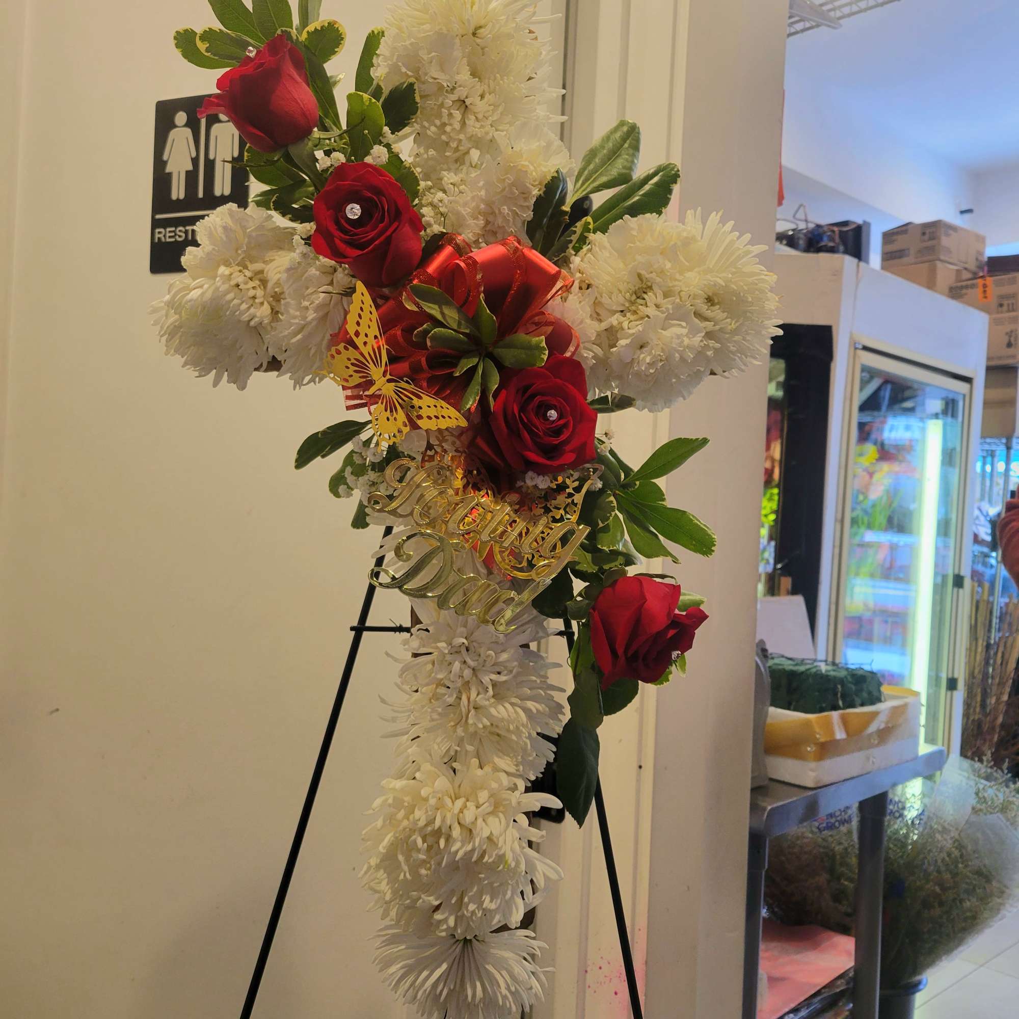 Standing floral cross with red roses and white chrysanthemums