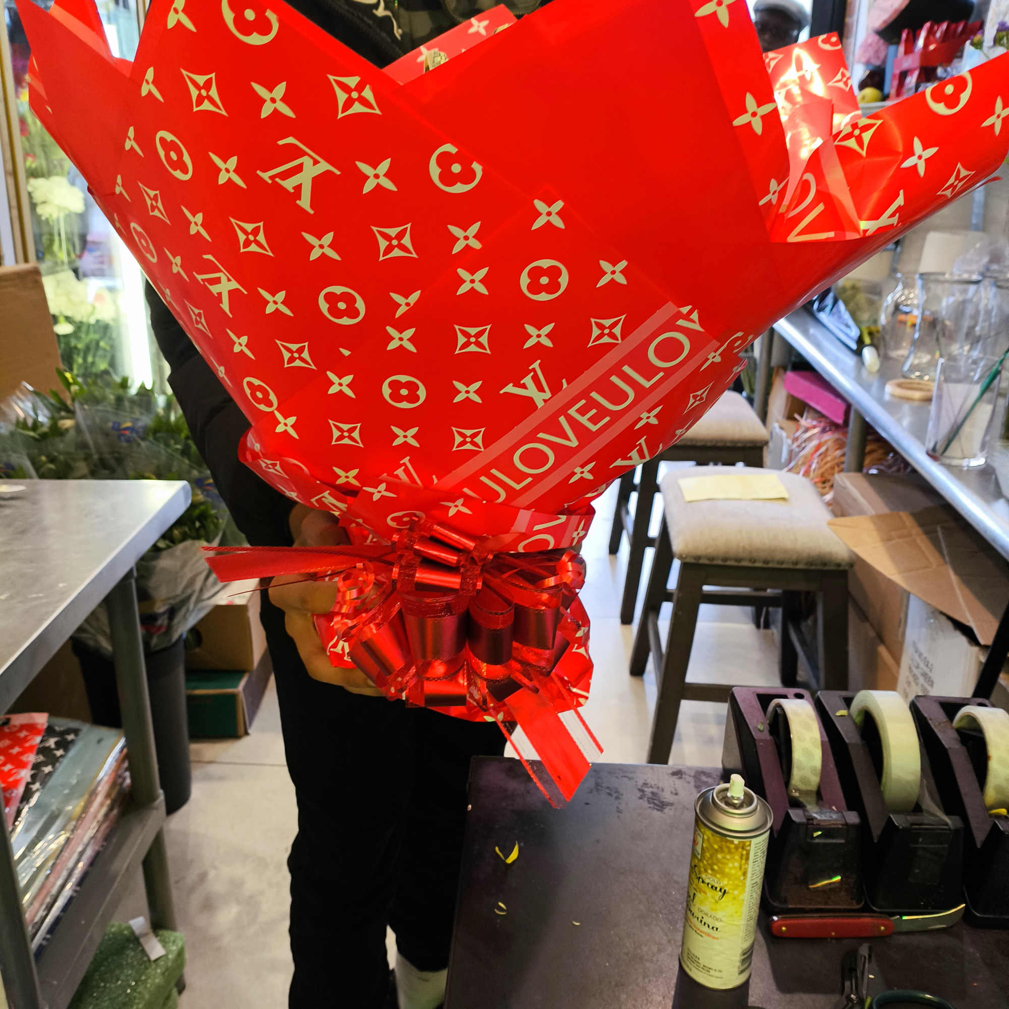 Large red wrapped bouquet with a ribbon bow