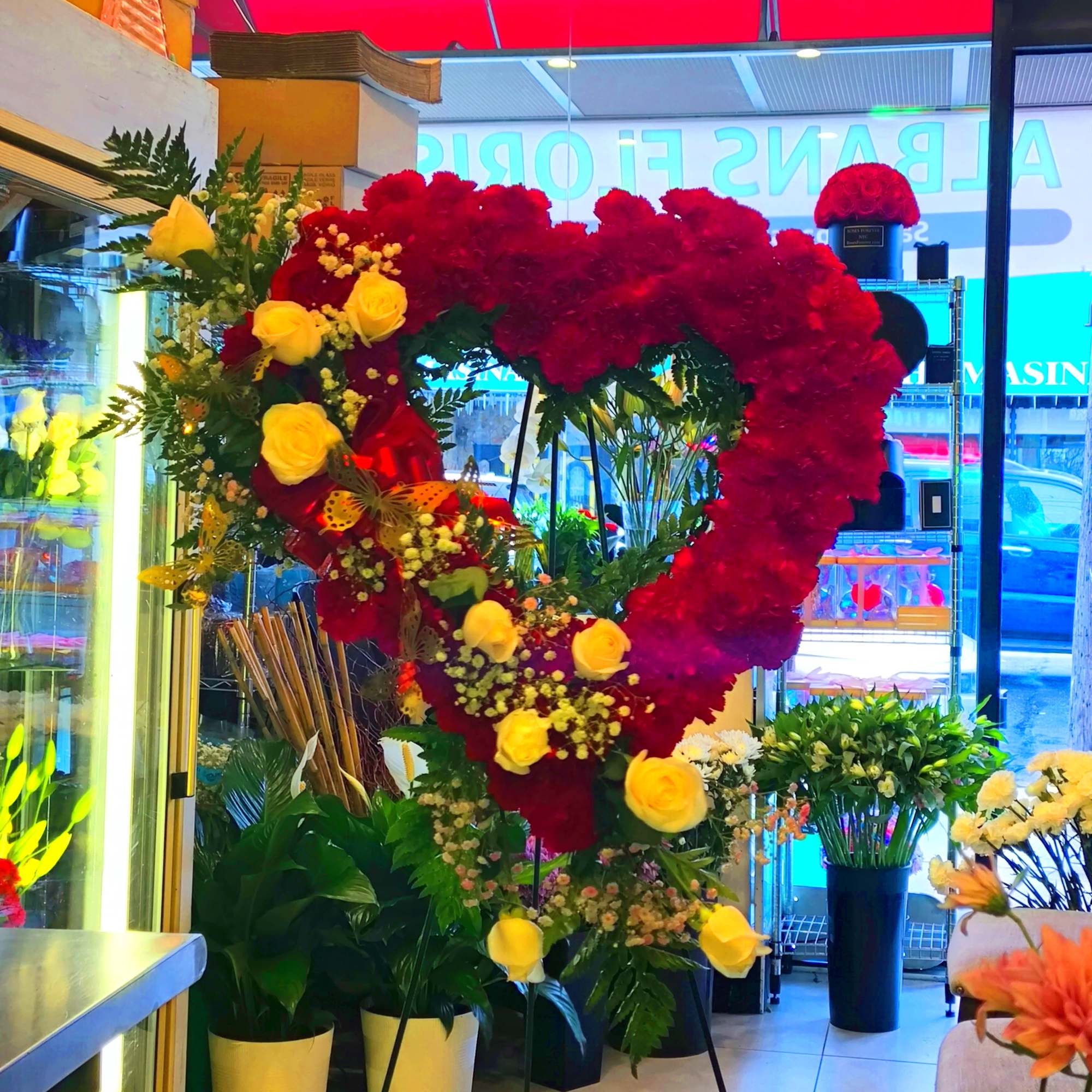 Large heart-shaped floral display with red and yellow roses