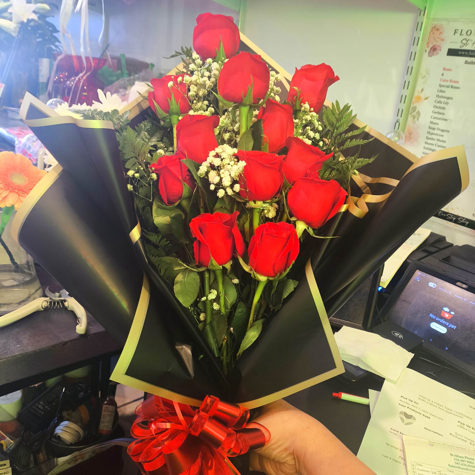 Bouquet of red roses with baby's breath in black wrap and red ribbon, photo 3 of 3