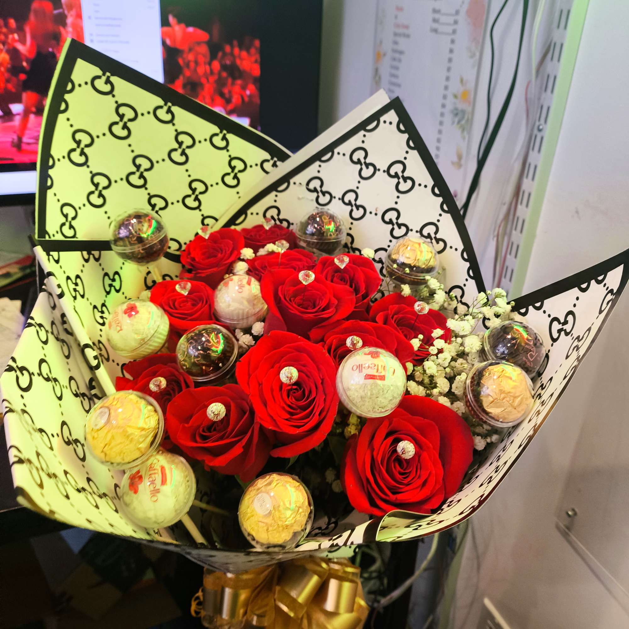 Bouquet of red roses with Ferrero Rocher chocolates in patterned wrap