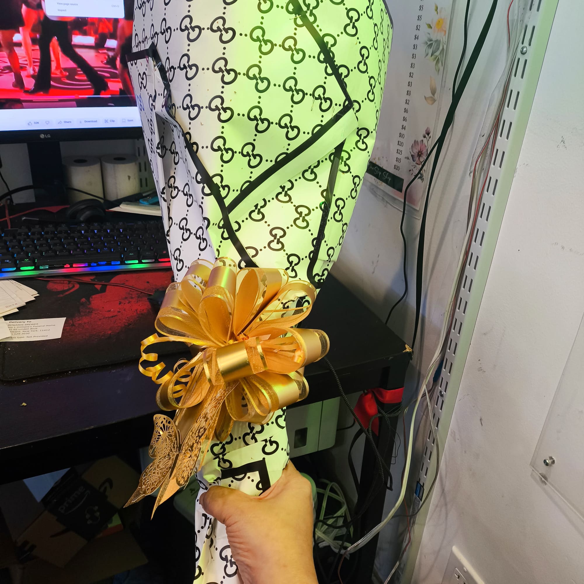 Wrapped bouquet with a gold ribbon bow