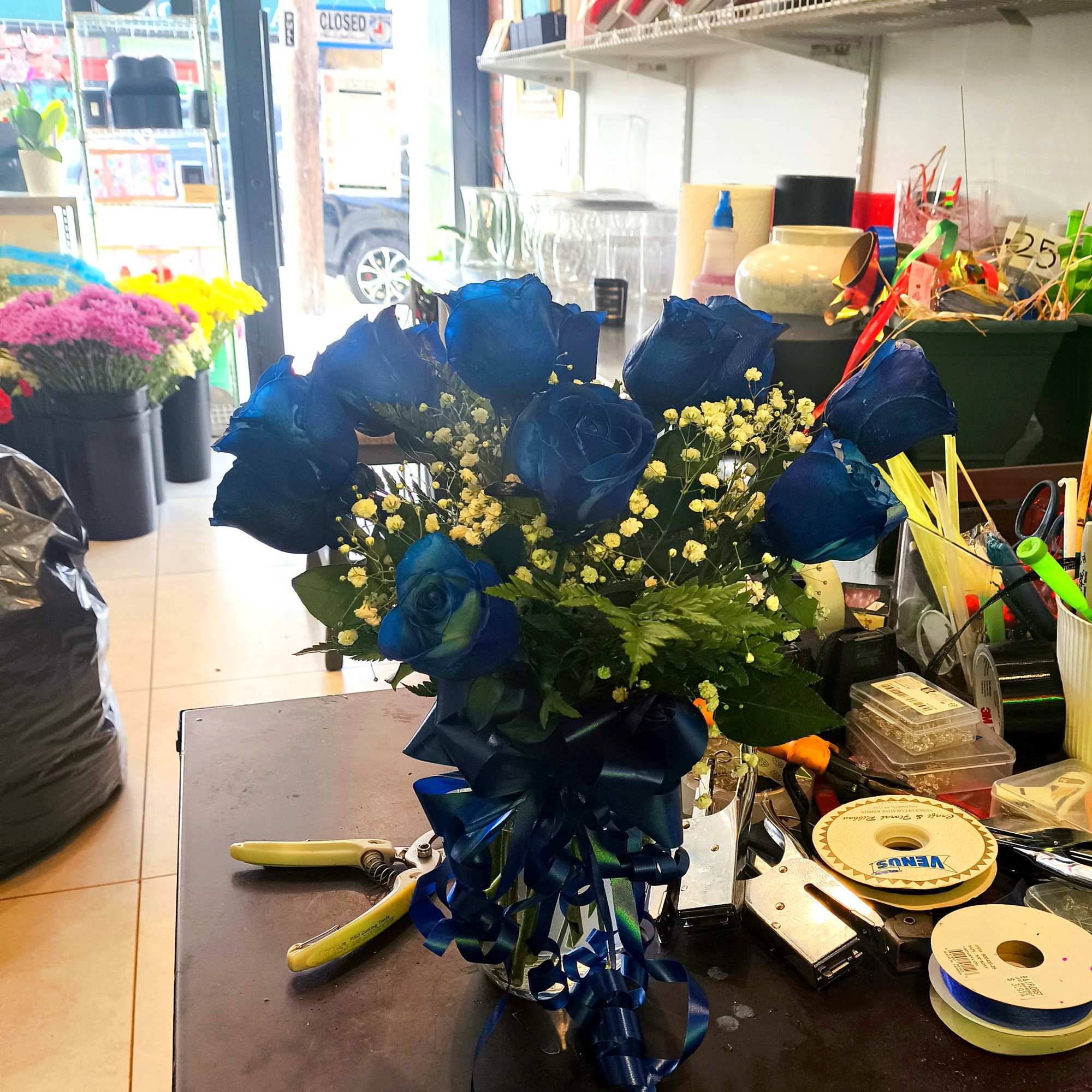 Bouquet of blue roses with baby's breath and a ribbon bow