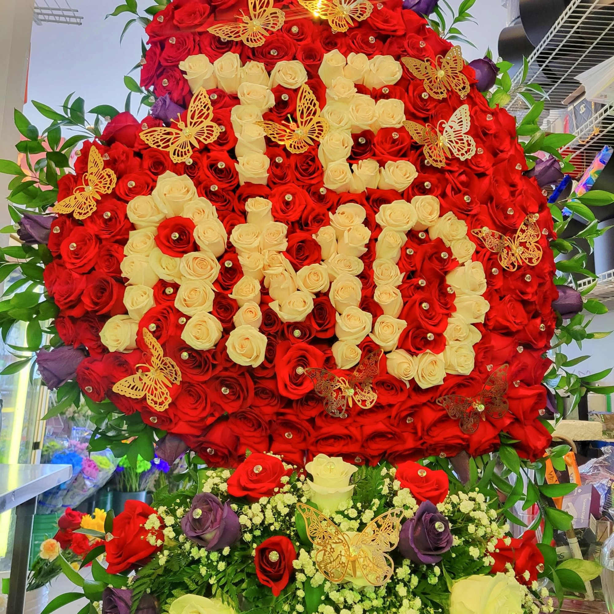 Large red and cream rose display with butterfly accents, photo 4 of 4