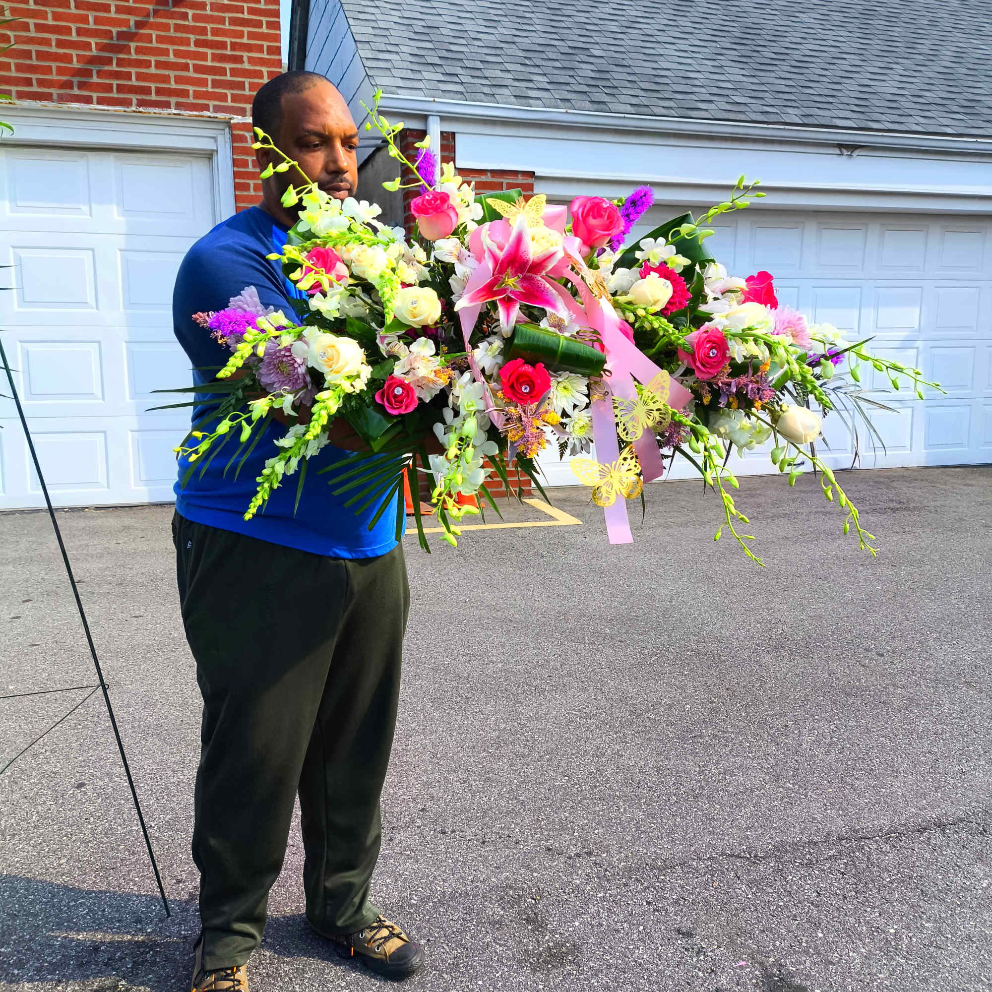 Large colorful floral arrangement with pink lilies and roses