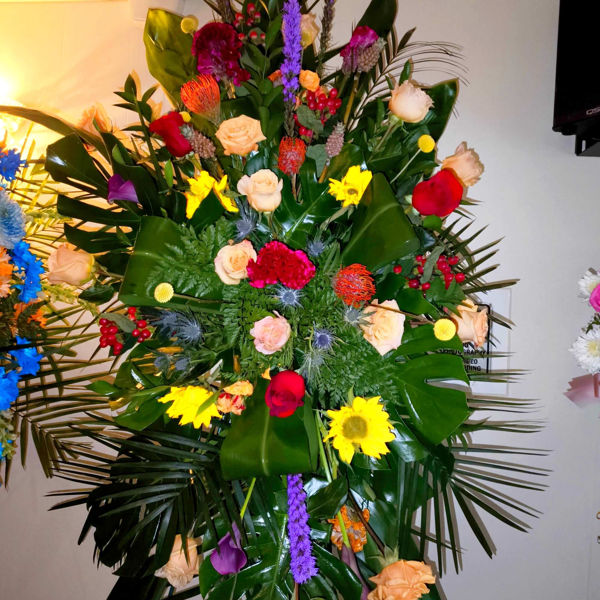 Tall standing floral spray with roses and bright mixed blooms, photo 4 of 5