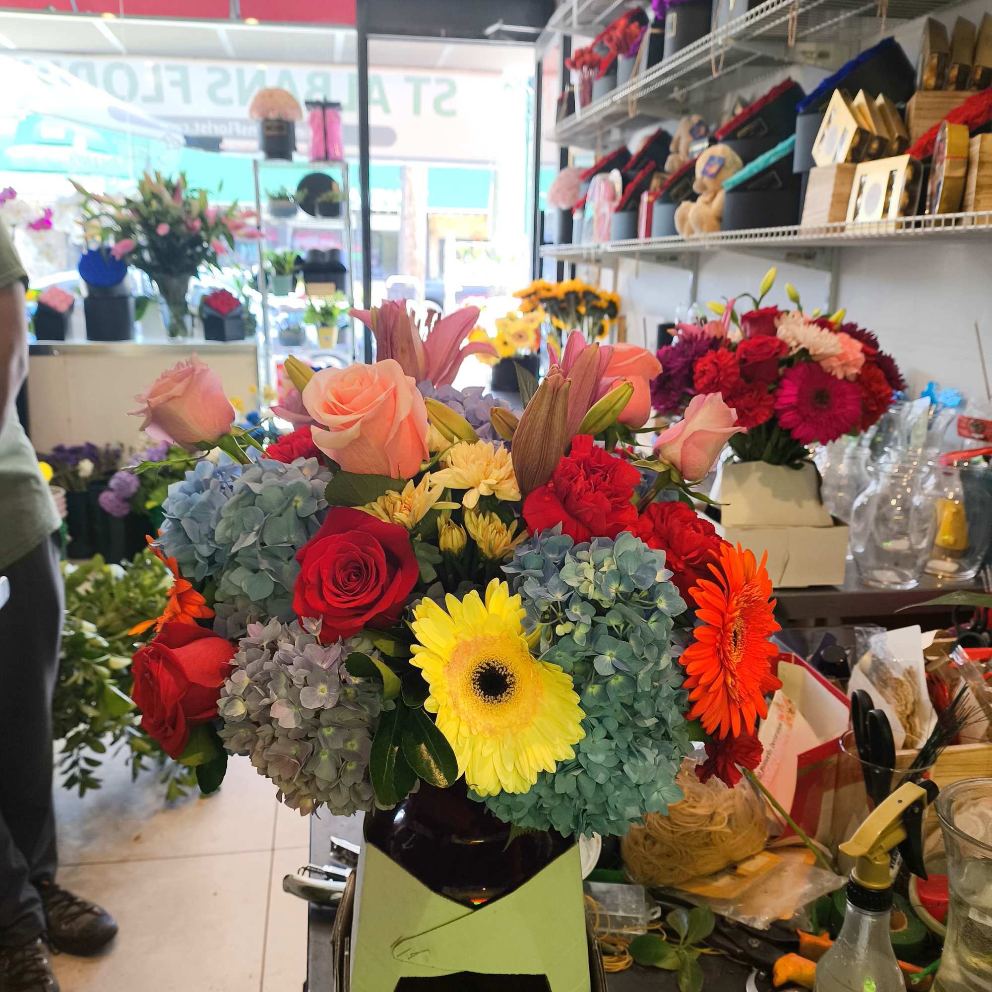 Mixed bouquet with roses, hydrangeas, gerbera daisies, and lilies in a vase