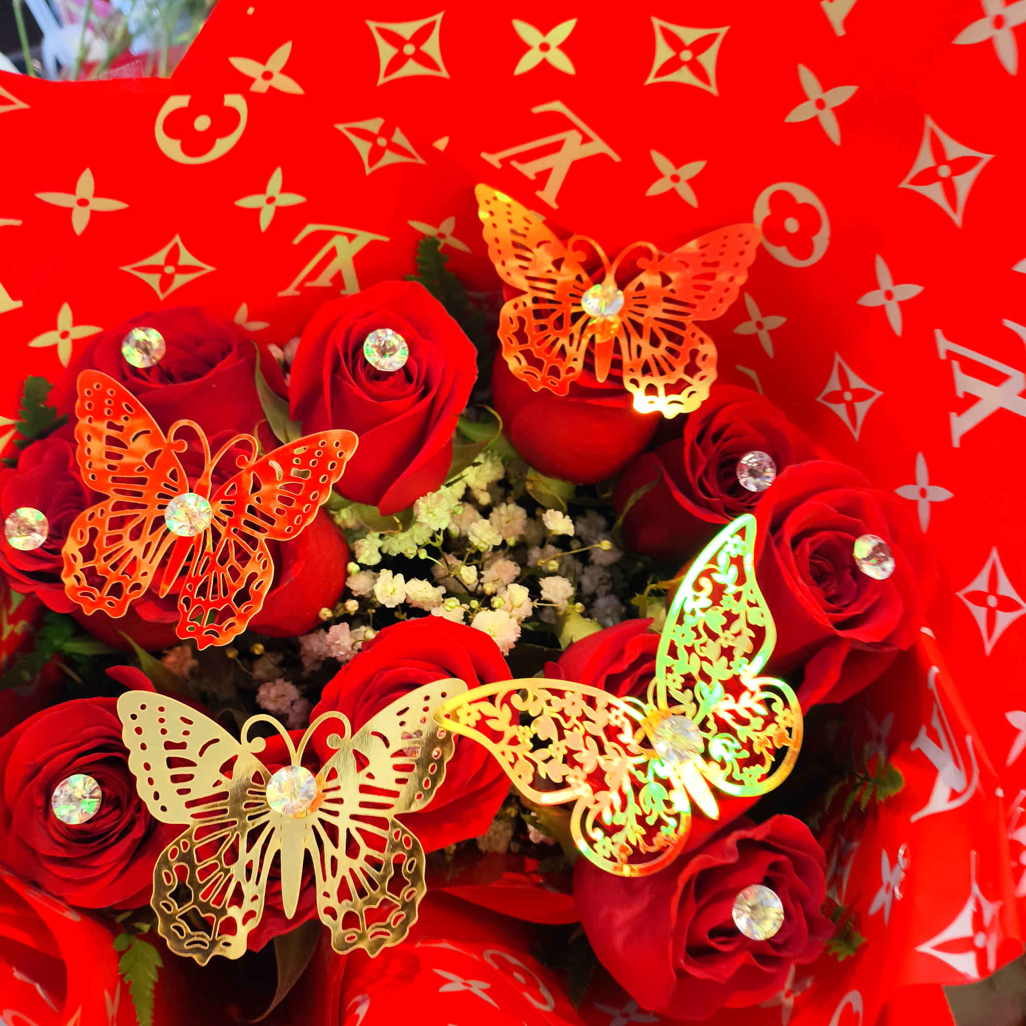 Bouquet of red roses wrapped in bright red patterned paper