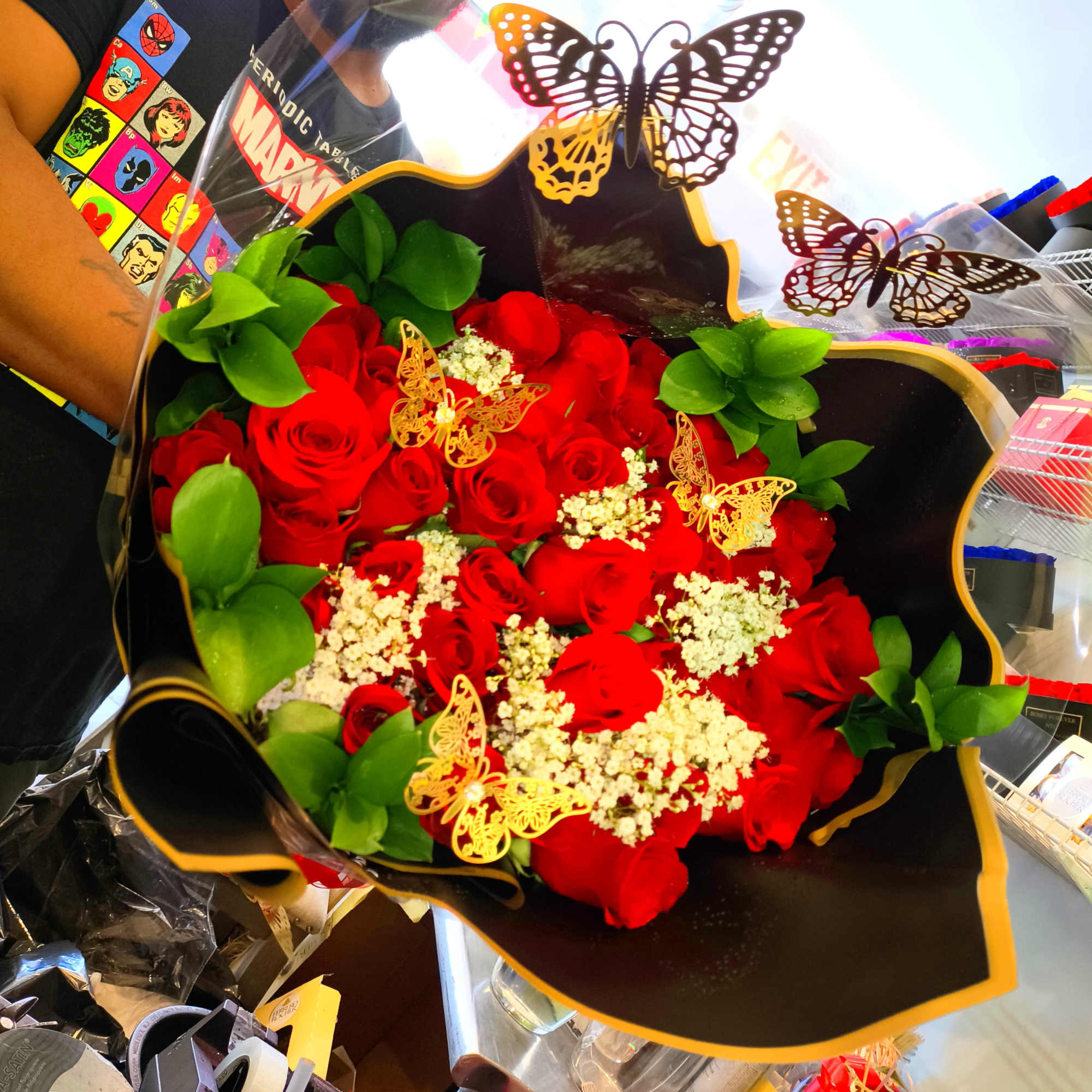 Bouquet of red roses with green leaves and butterfly decorations, photo 7 of 8