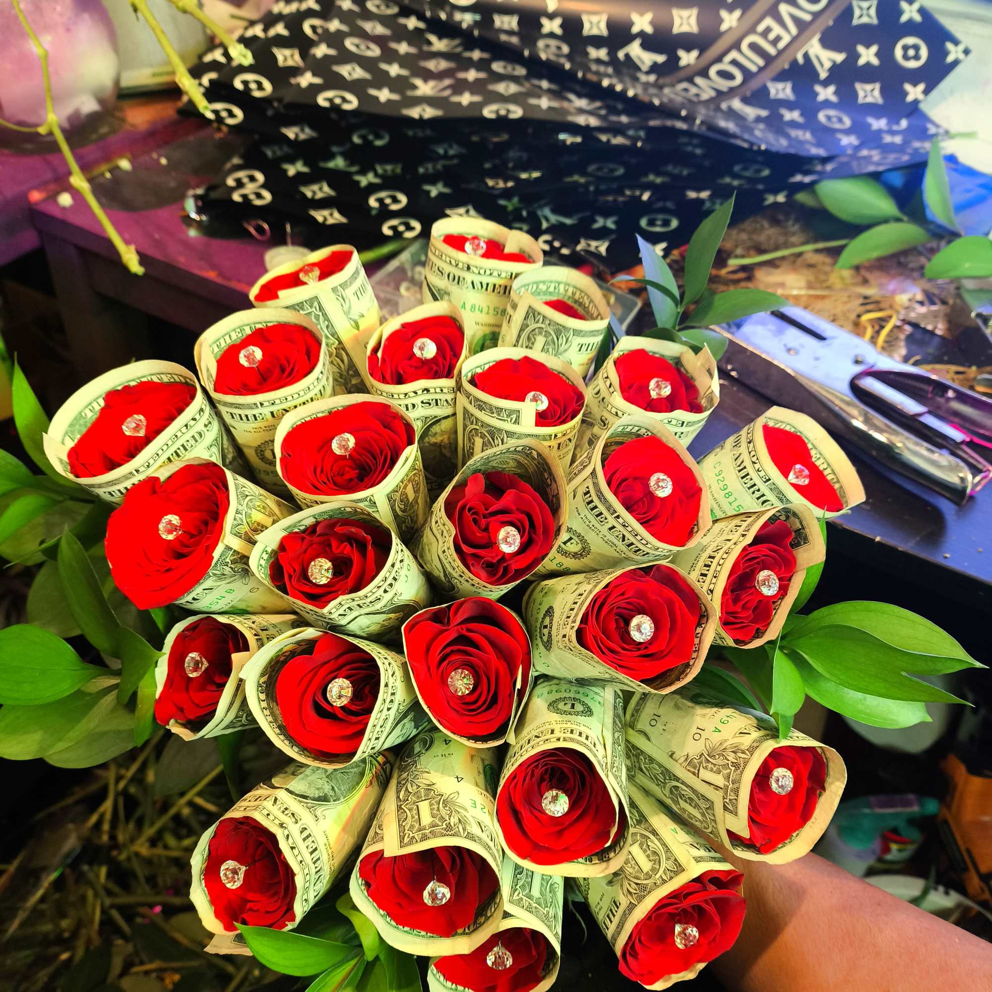 Bouquet of red roses wrapped in dollar bills
