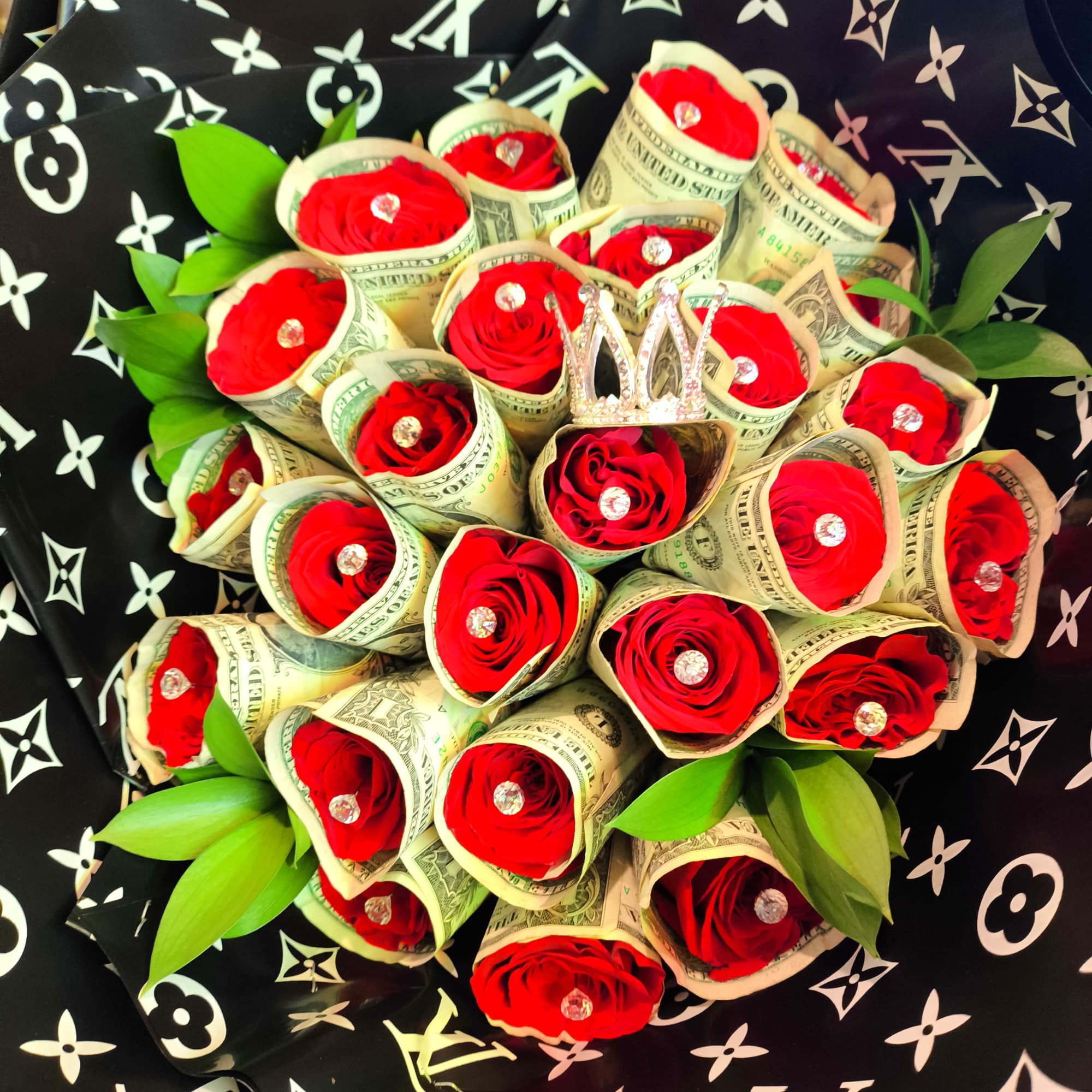 Bouquet of red roses wrapped in dollar bills with green leaves