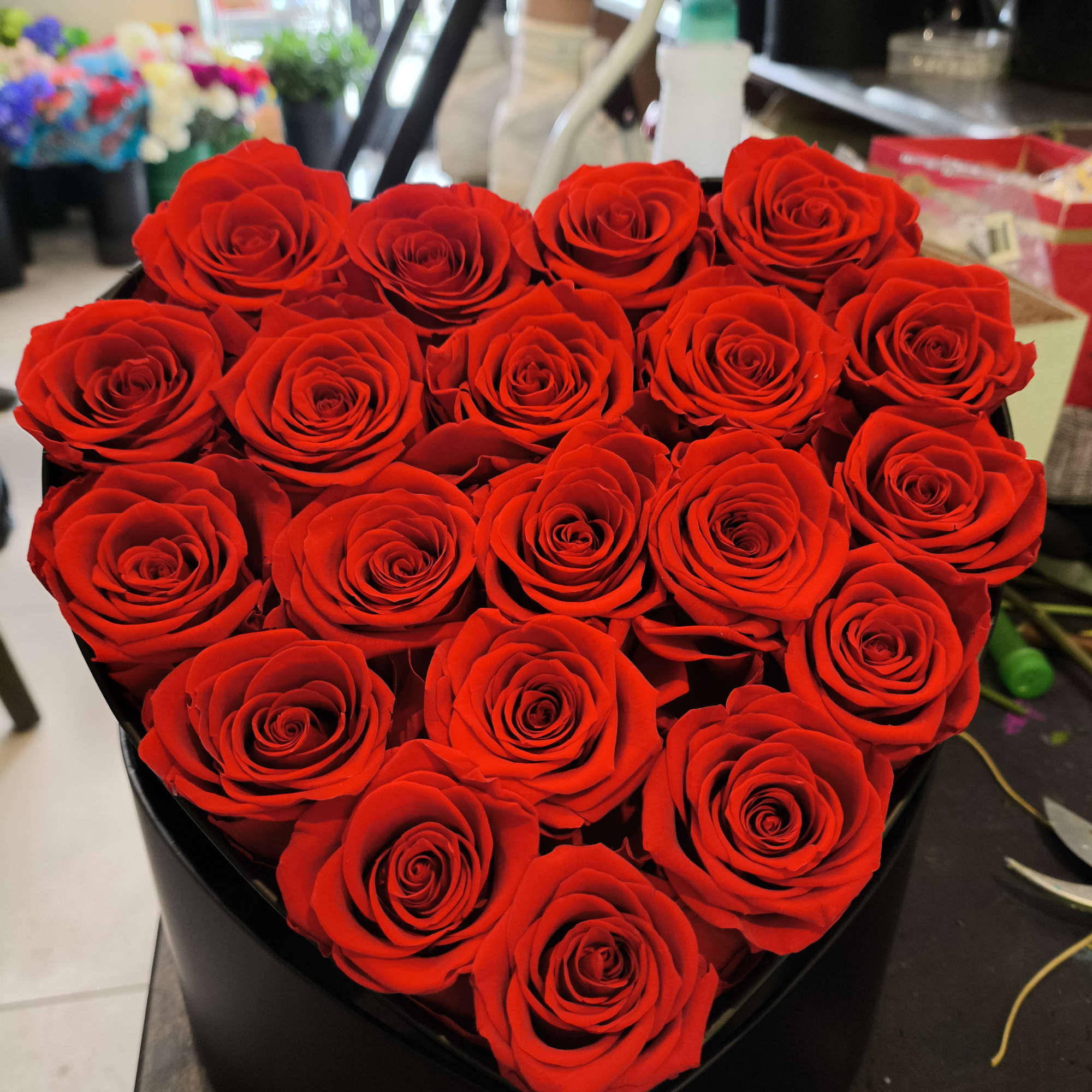 Heart-shaped box filled with red roses