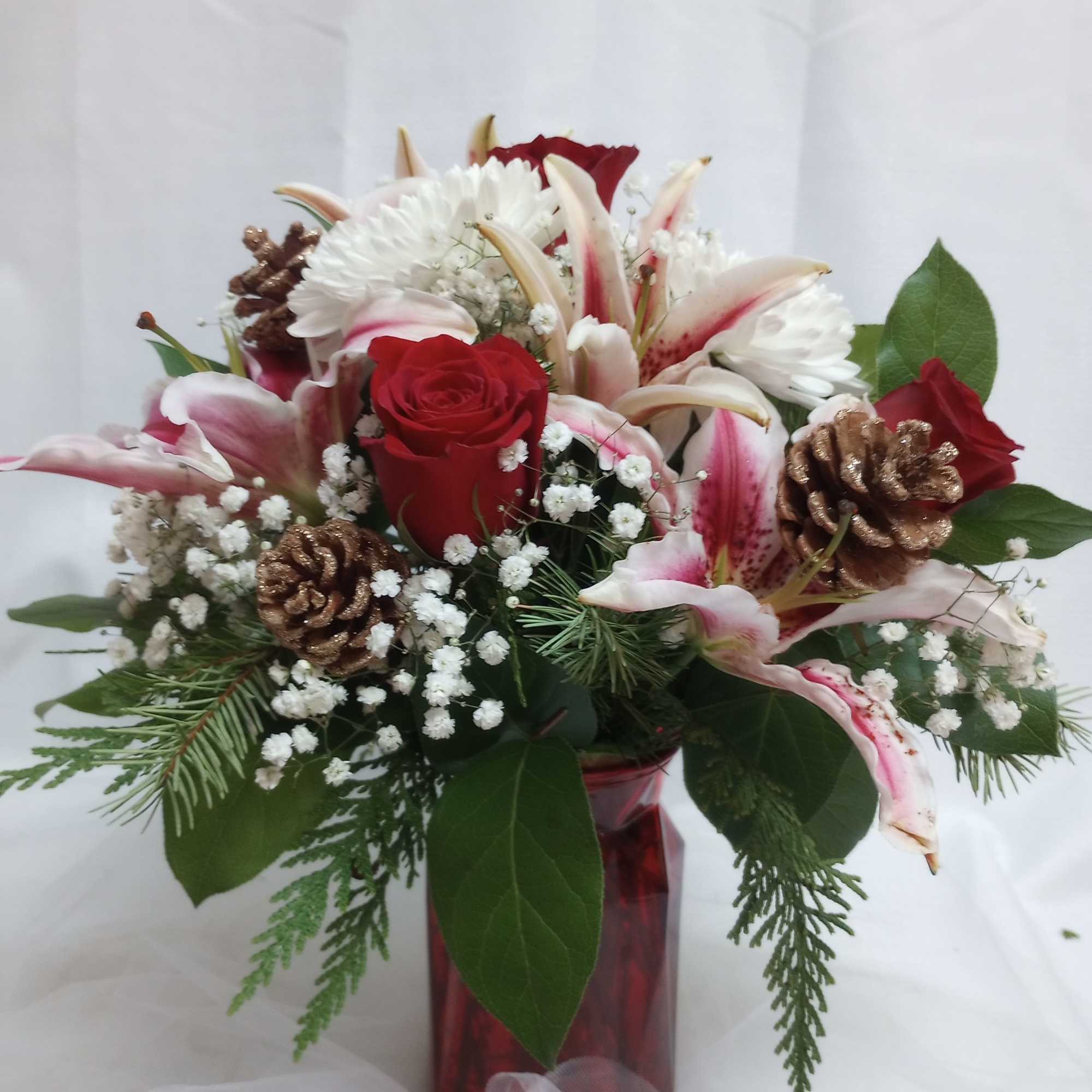 Celebrate the season with this vibrant display of red roses and hot