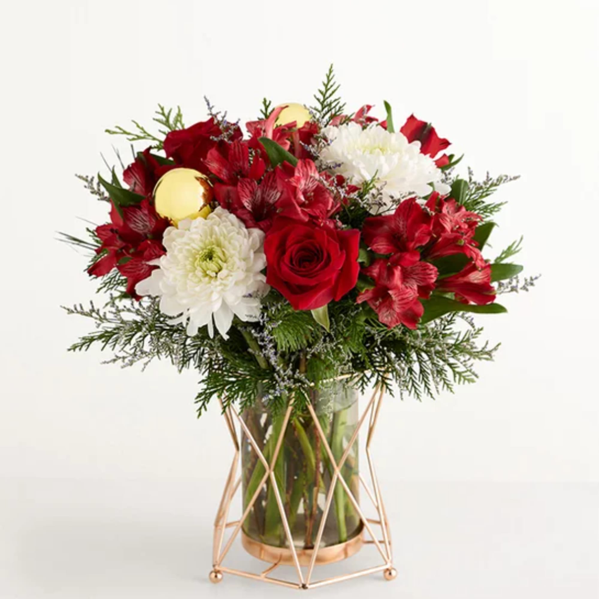 Red roses and white chrysanthemums in a glass vase with gold stand