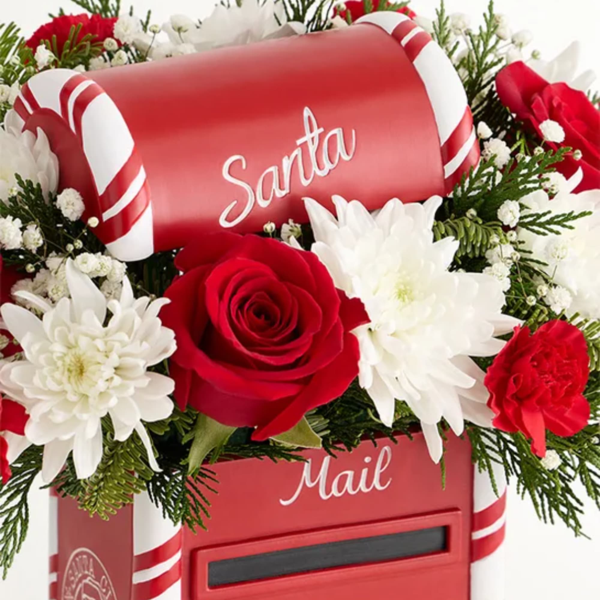 Red mailbox with white and red flowers arranged around it