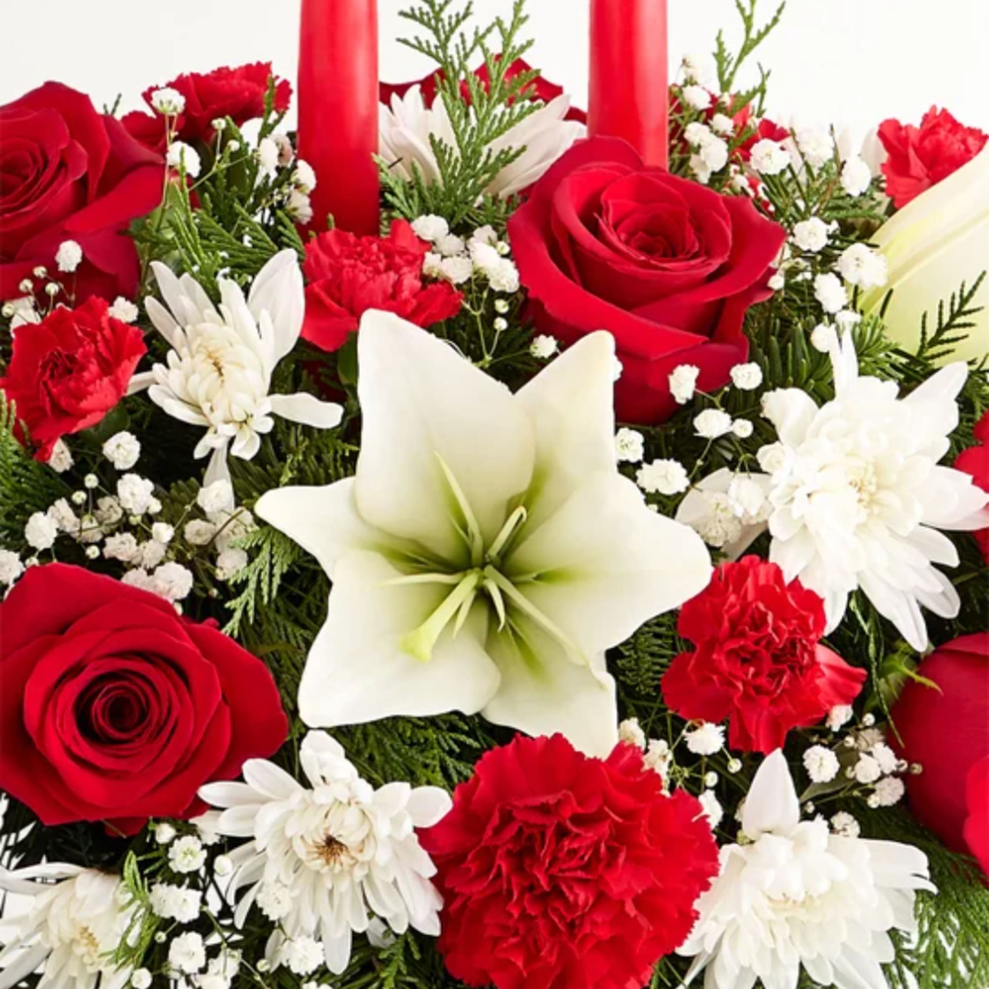 Red roses and white lilies with carnations and daisies in a dense arrangement