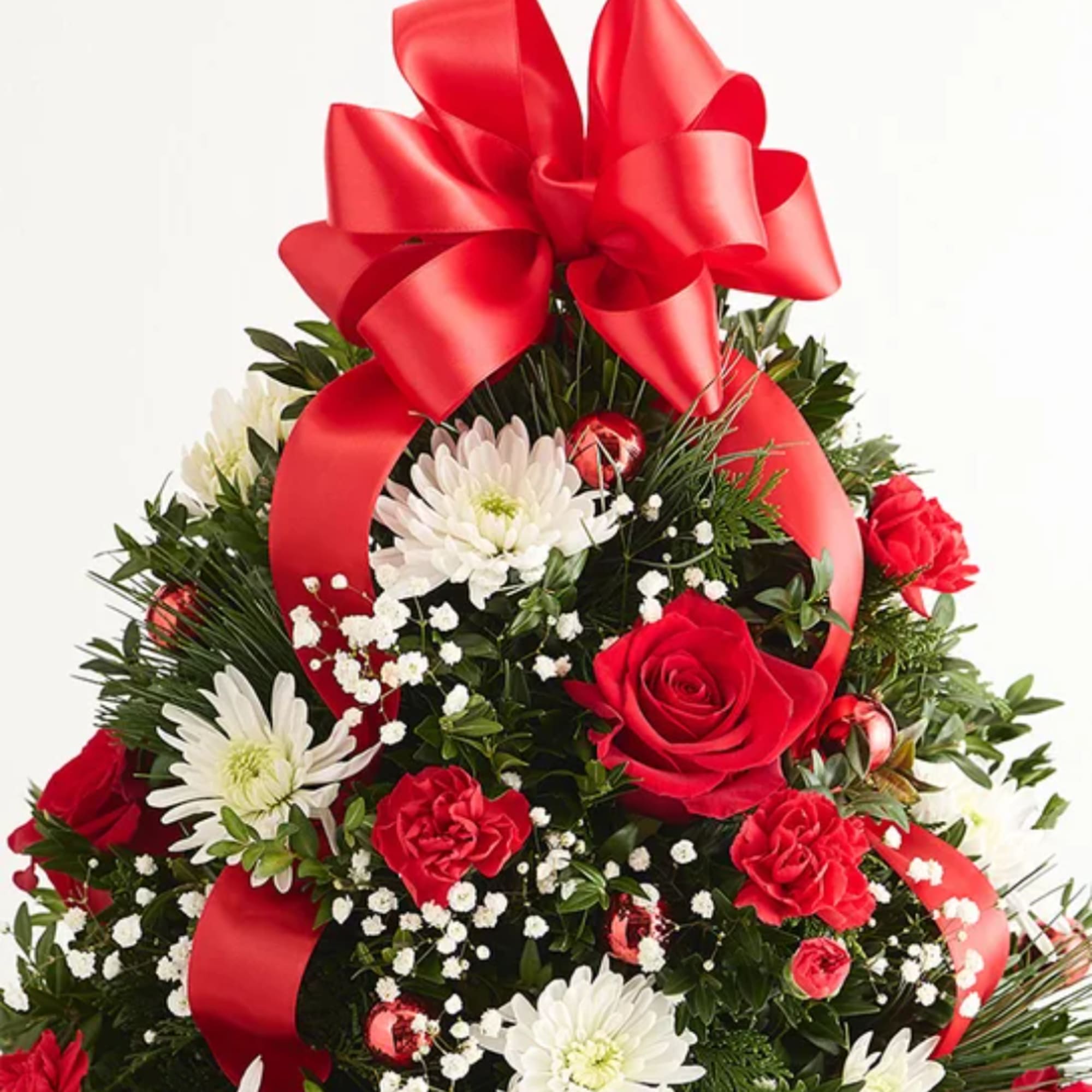 Red and white floral arrangement topped with a large red bow