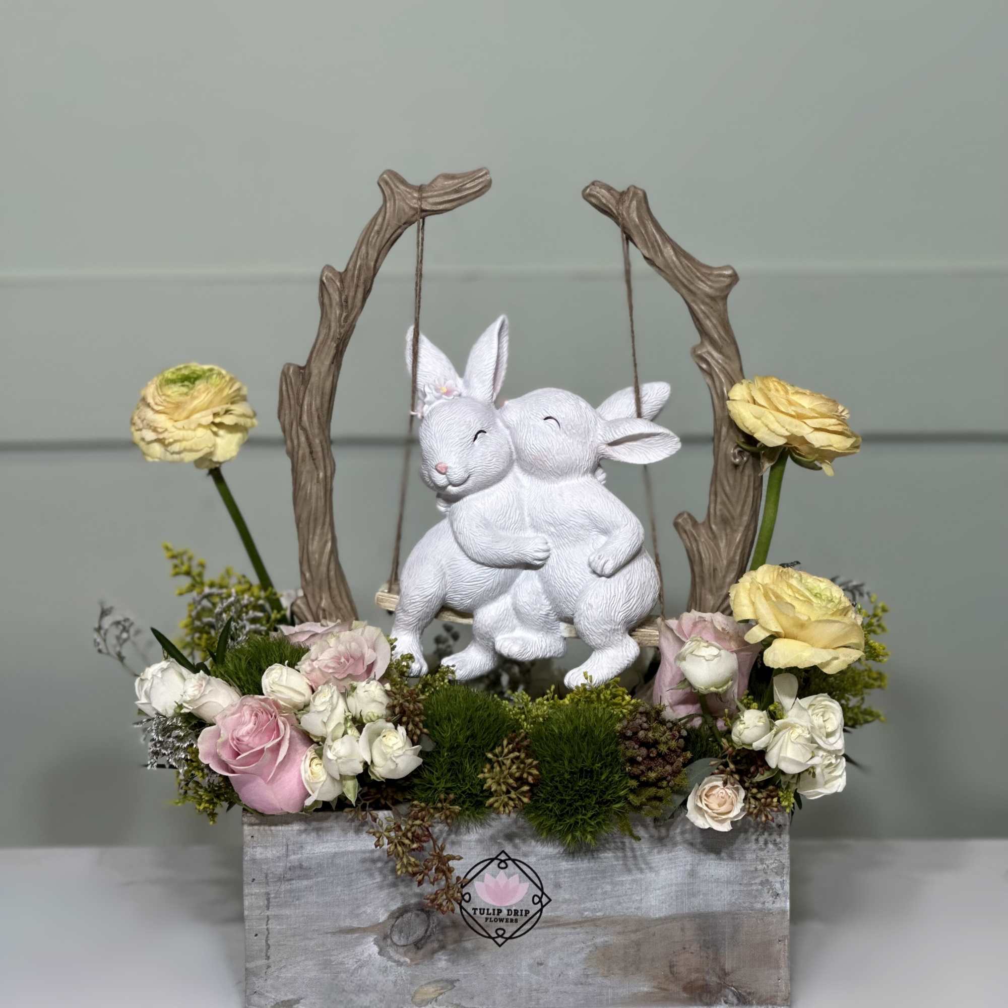 Roses, Ranunculuses , Spray roses and a ceramic statue of two loving
