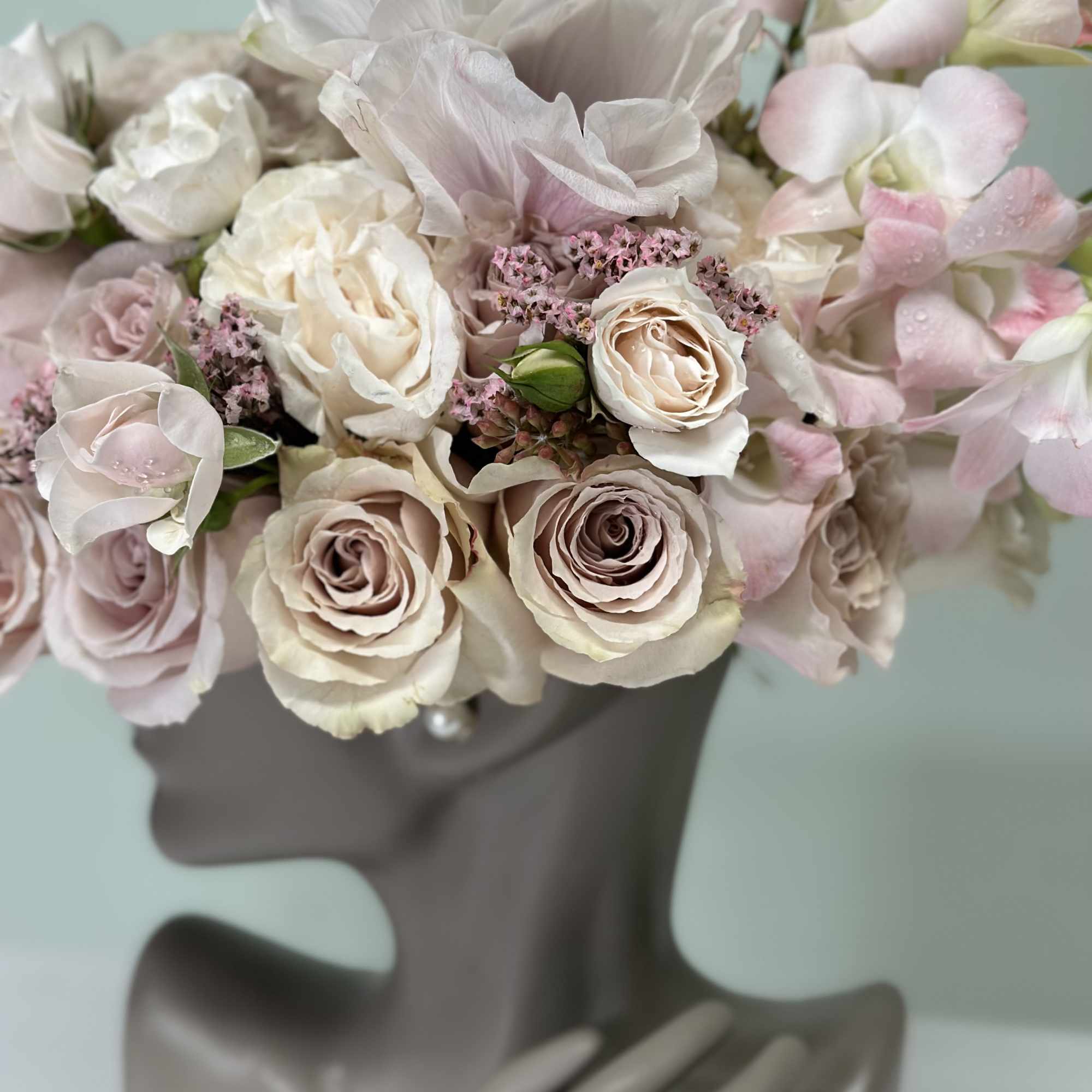 Bouquet of pale pink and white roses with soft pink orchids