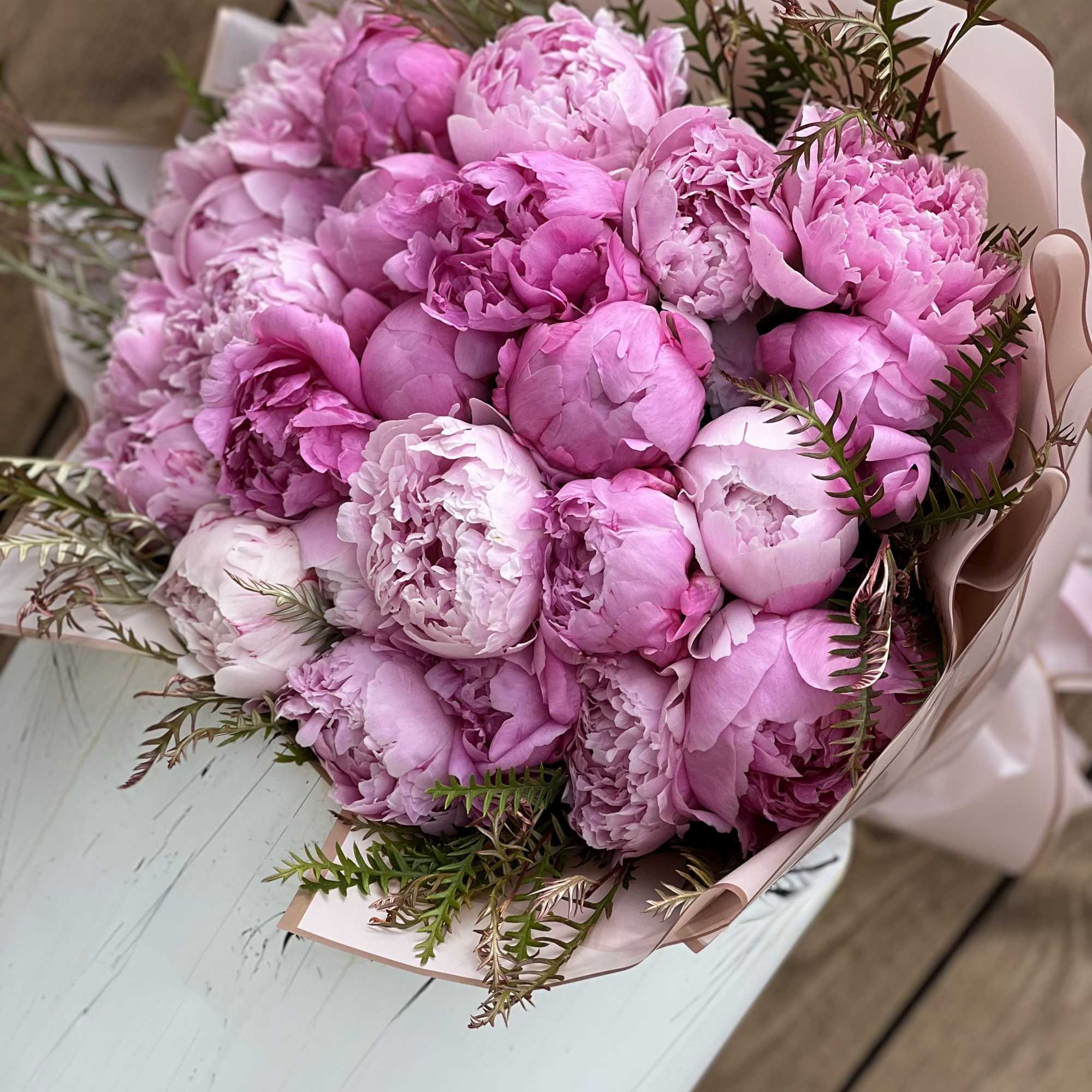 Bouquet of pink peonies wrapped in pale paper, photo 2 of 2