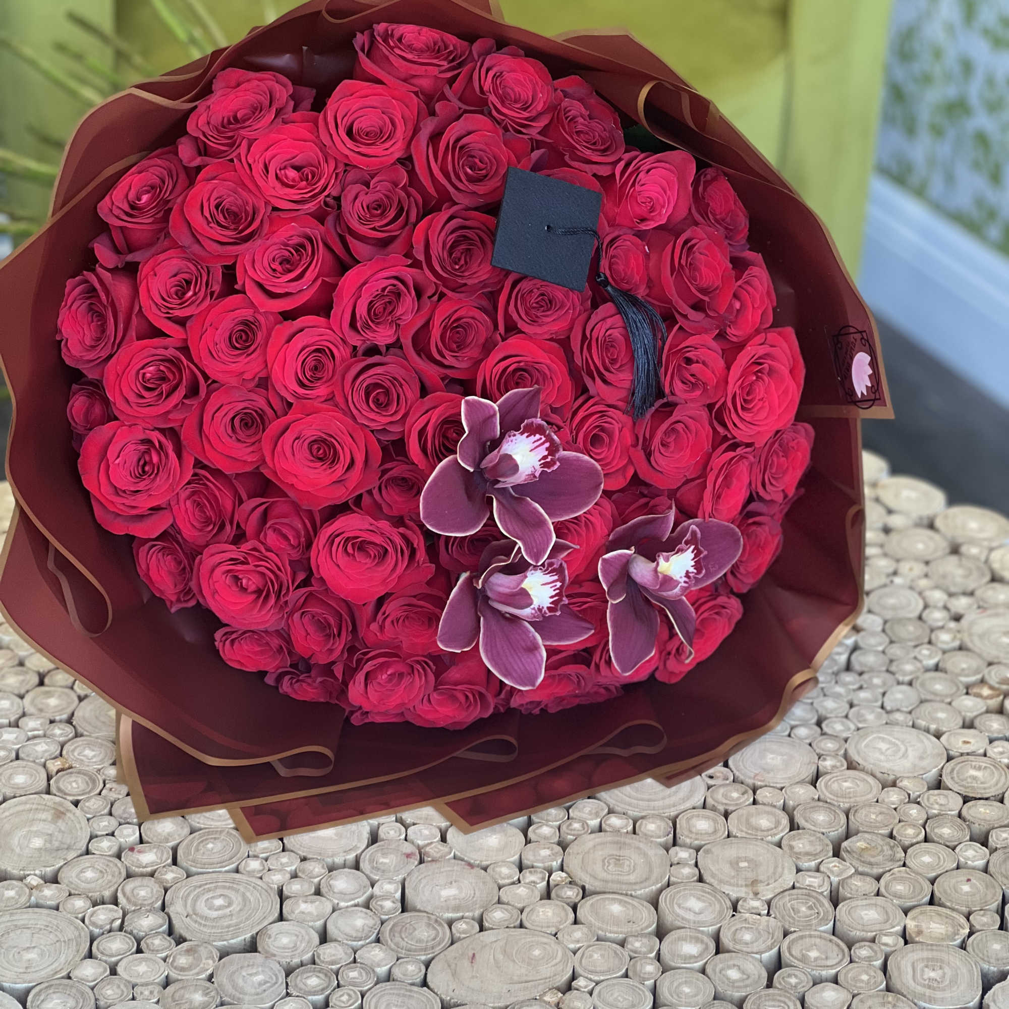 Bouquet of hot pink roses with three purple orchids