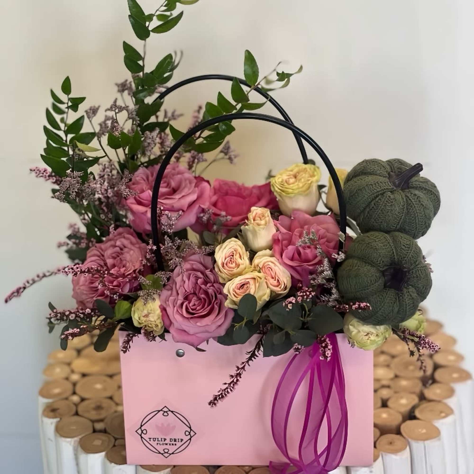 Pink and cream roses in a pink gift box with a ribbon