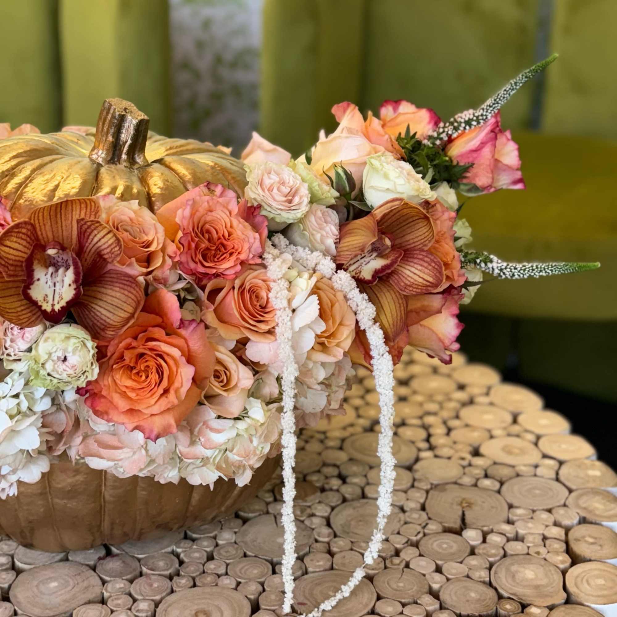 Pumpkin-shaped floral arrangement with peach roses and orchids