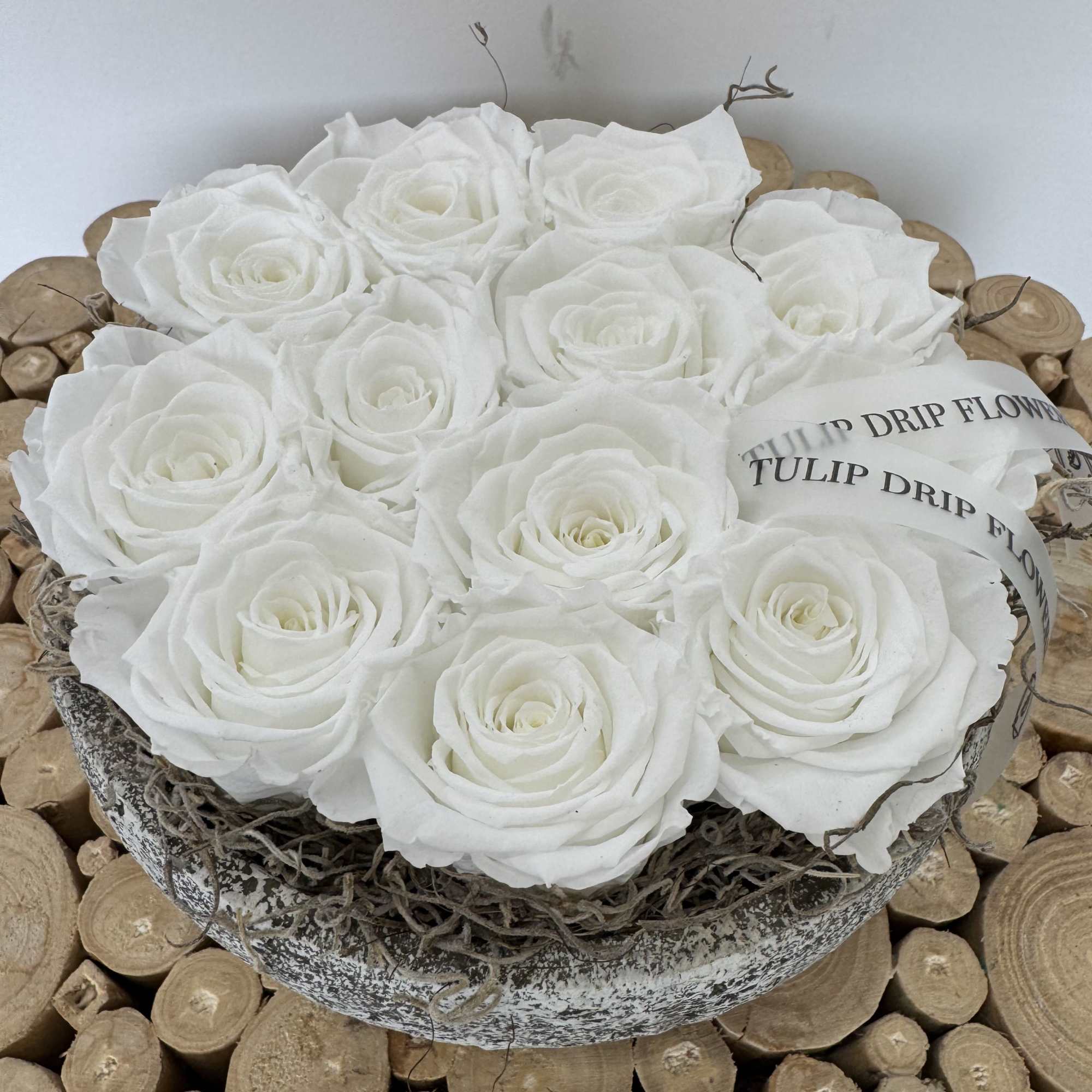 White roses arranged in a round decorative box