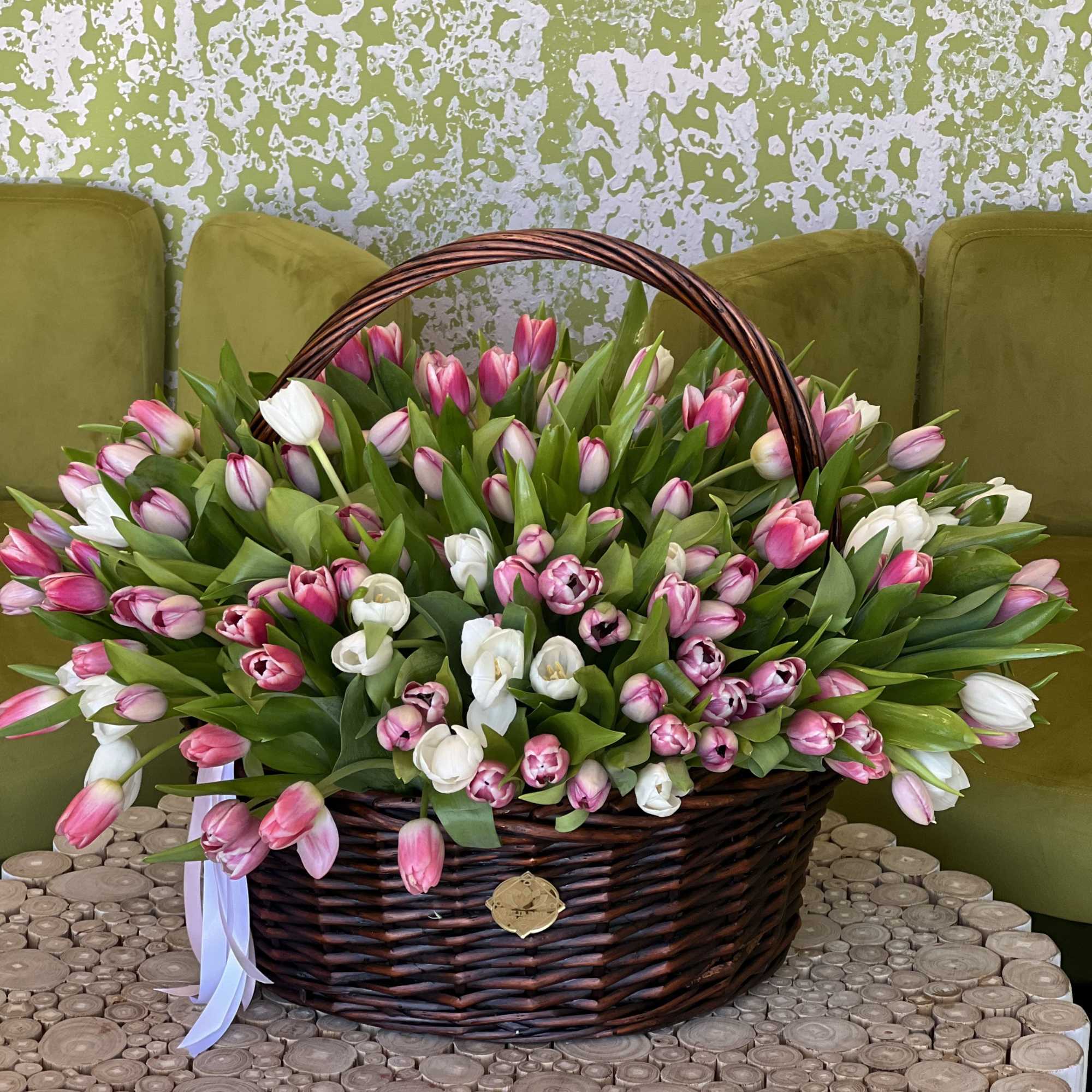 Basket of pink and white tulips with a ribbon bow