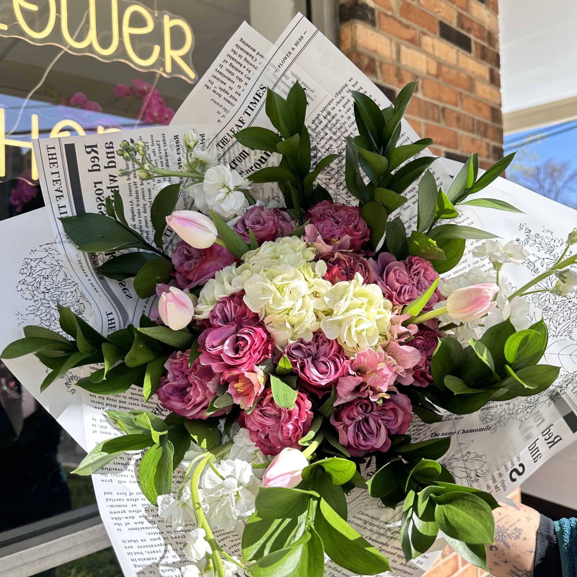 Pink and white bouquet with roses, hydrangea, and tulips in paper wrap