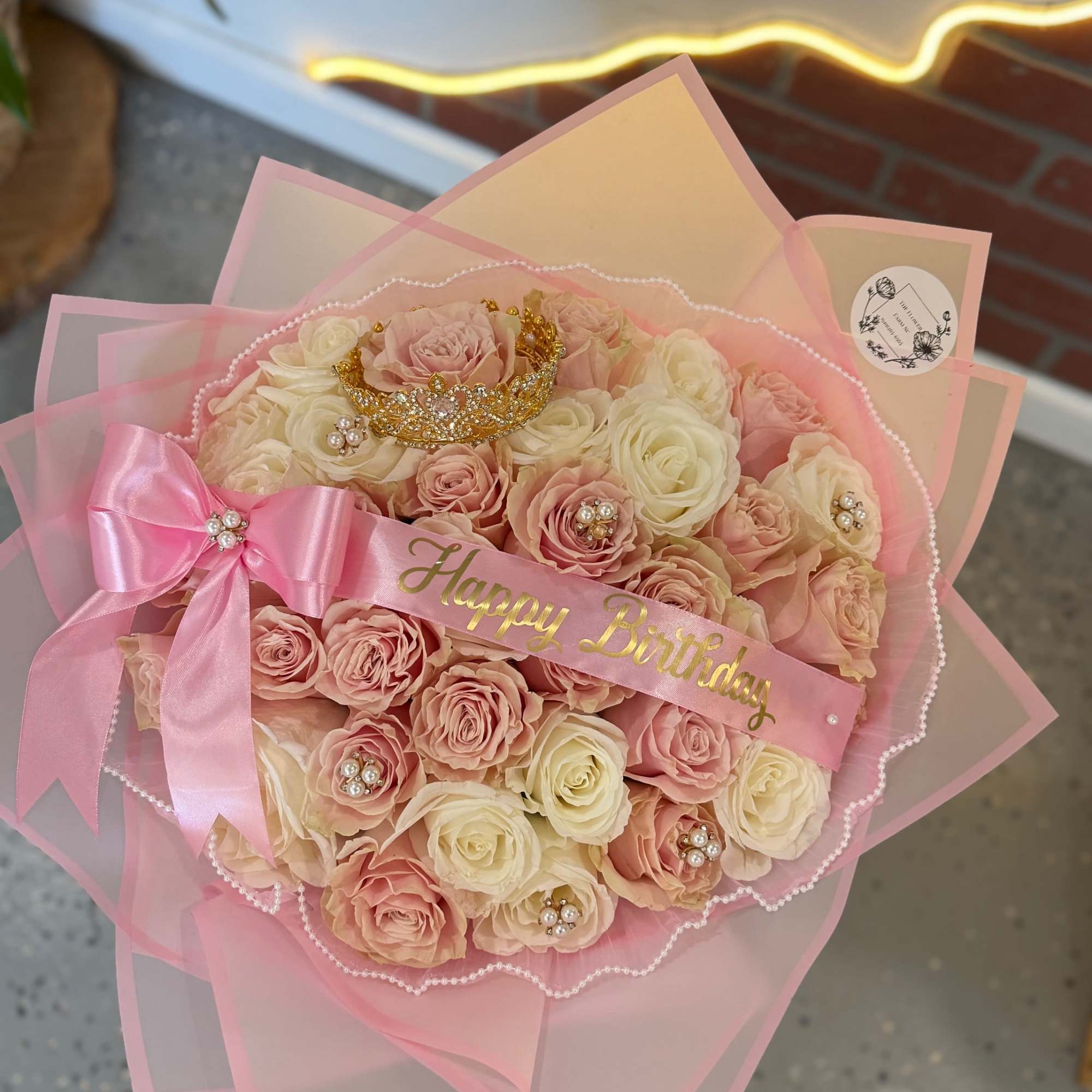 Pink and cream rose bouquet with a birthday ribbon and bow