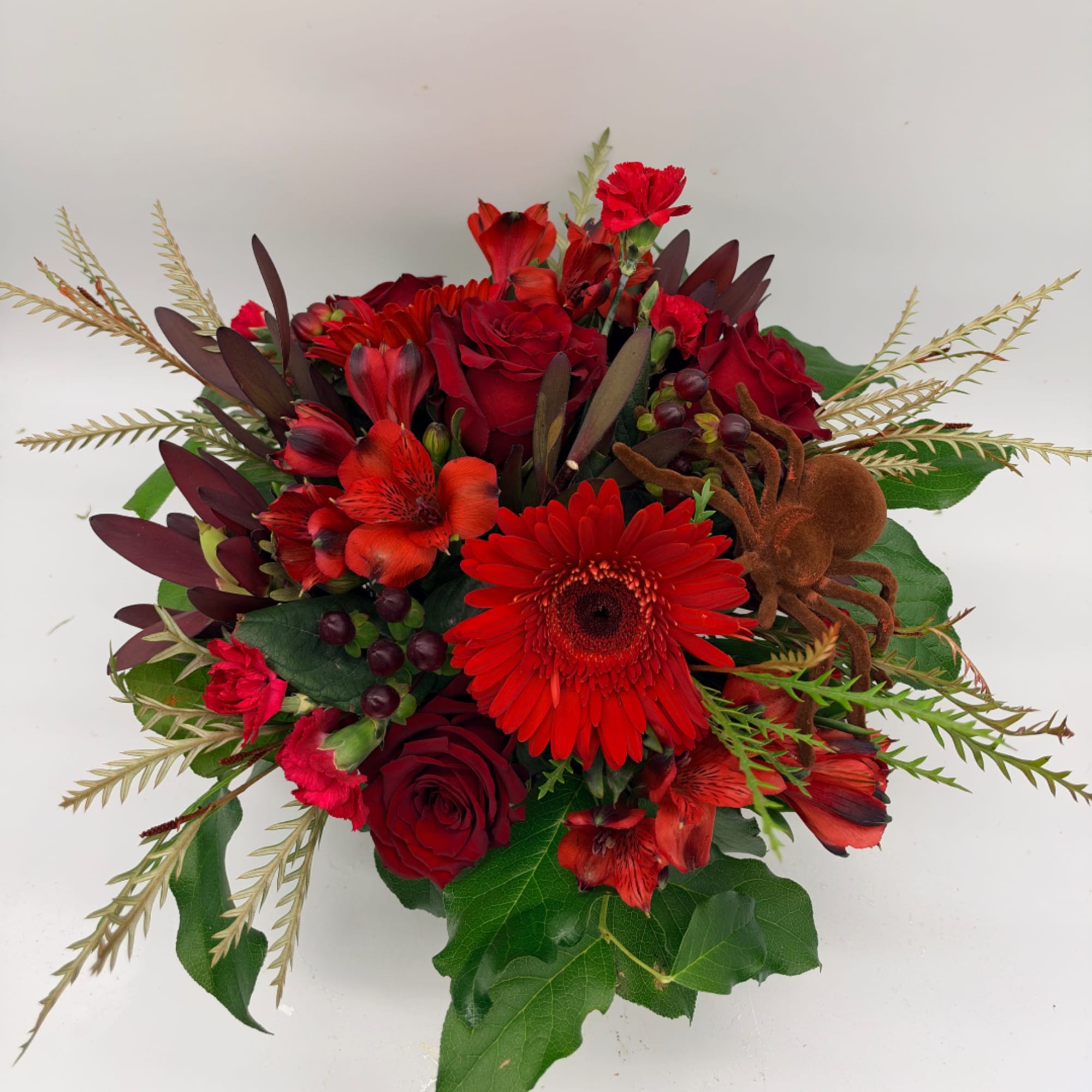 Red floral bouquet with roses, gerbera daisy, and alstroemeria
