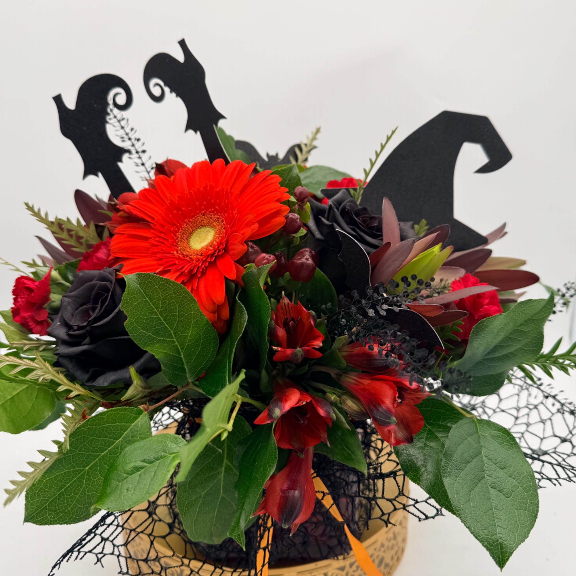Halloween bouquet with red gerbera daisies and black roses