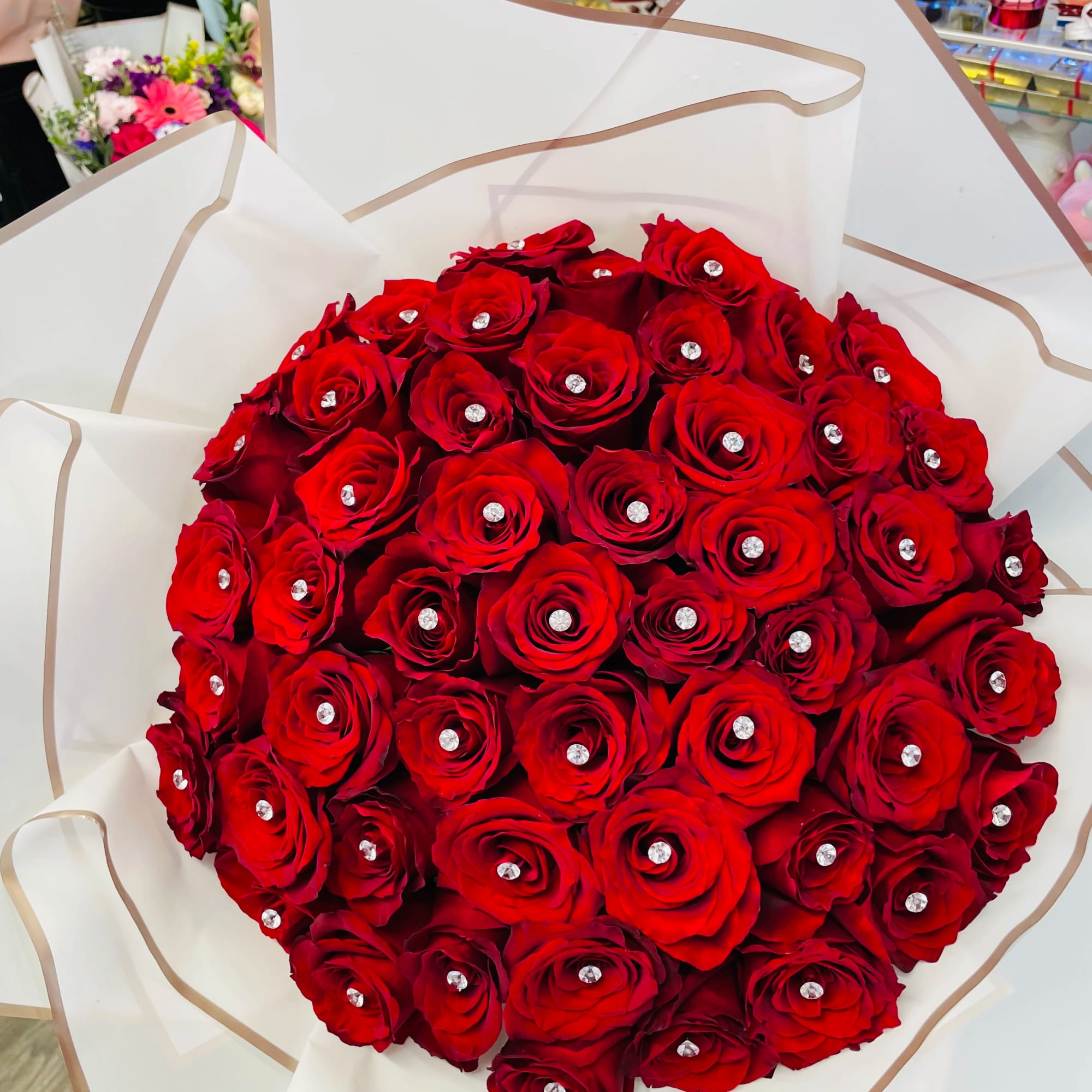 Large bouquet of red roses wrapped in white paper