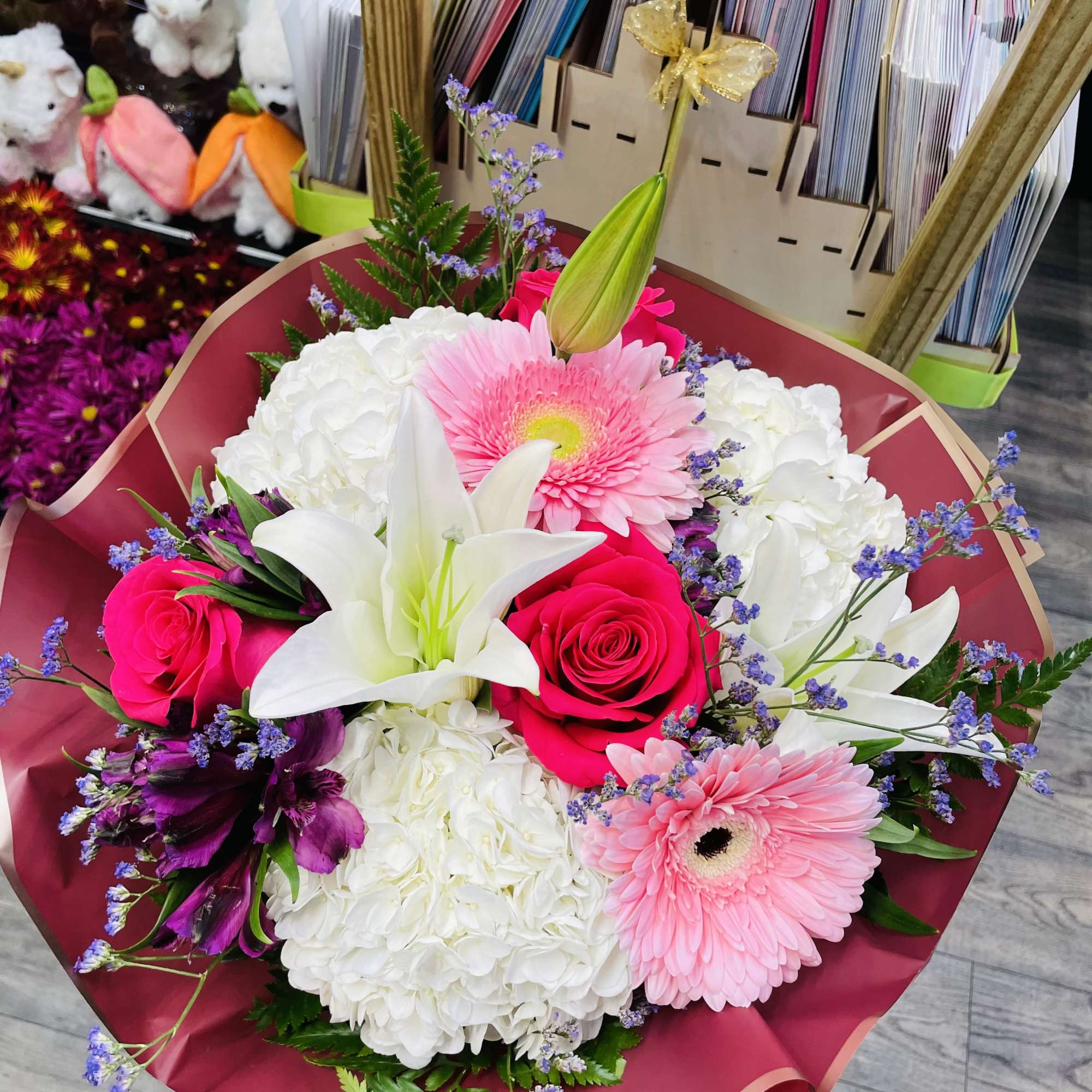 Bouquet of pink roses, white lilies, and pink gerbera daisies