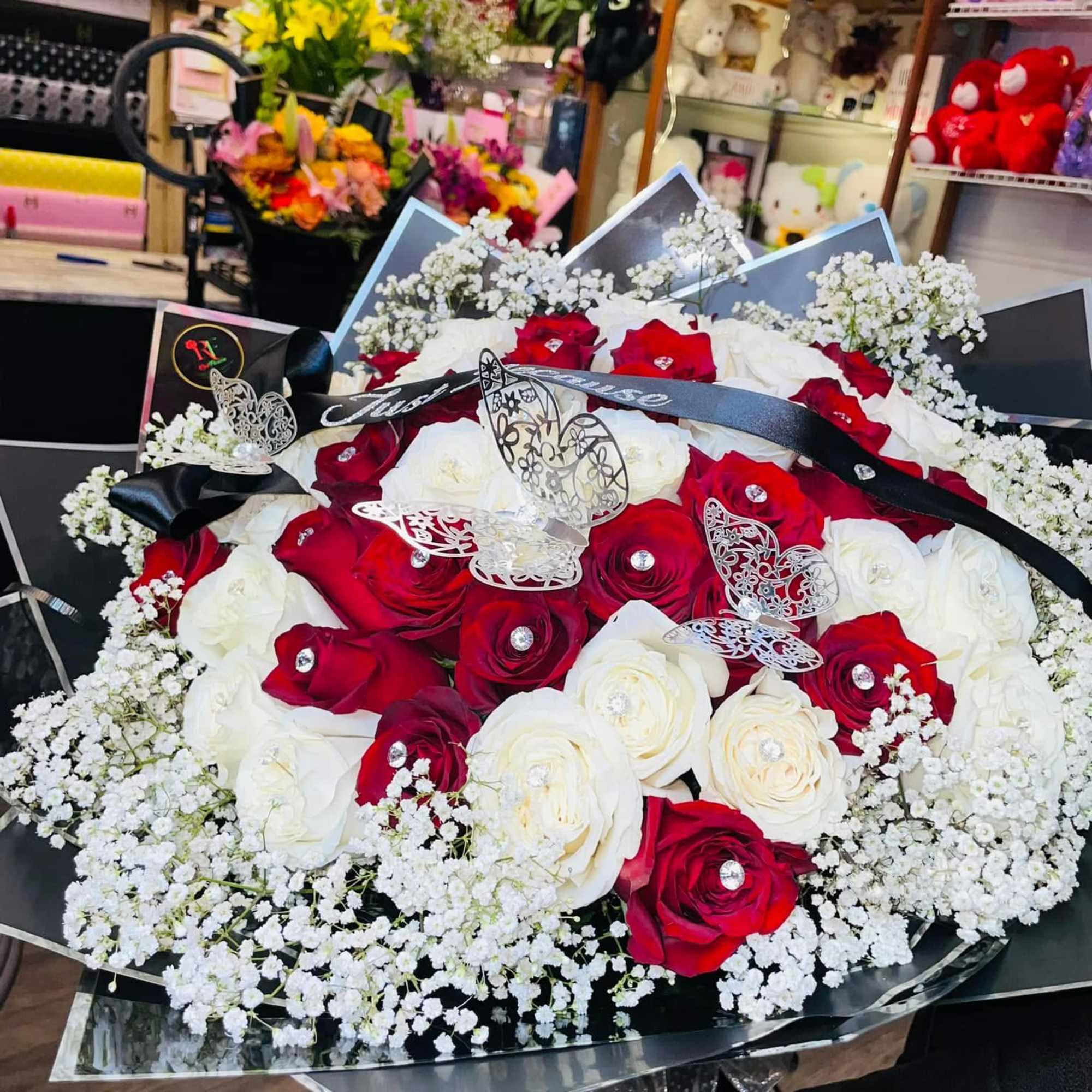 Bouquet of red and white roses with baby's breath and butterfly decorations